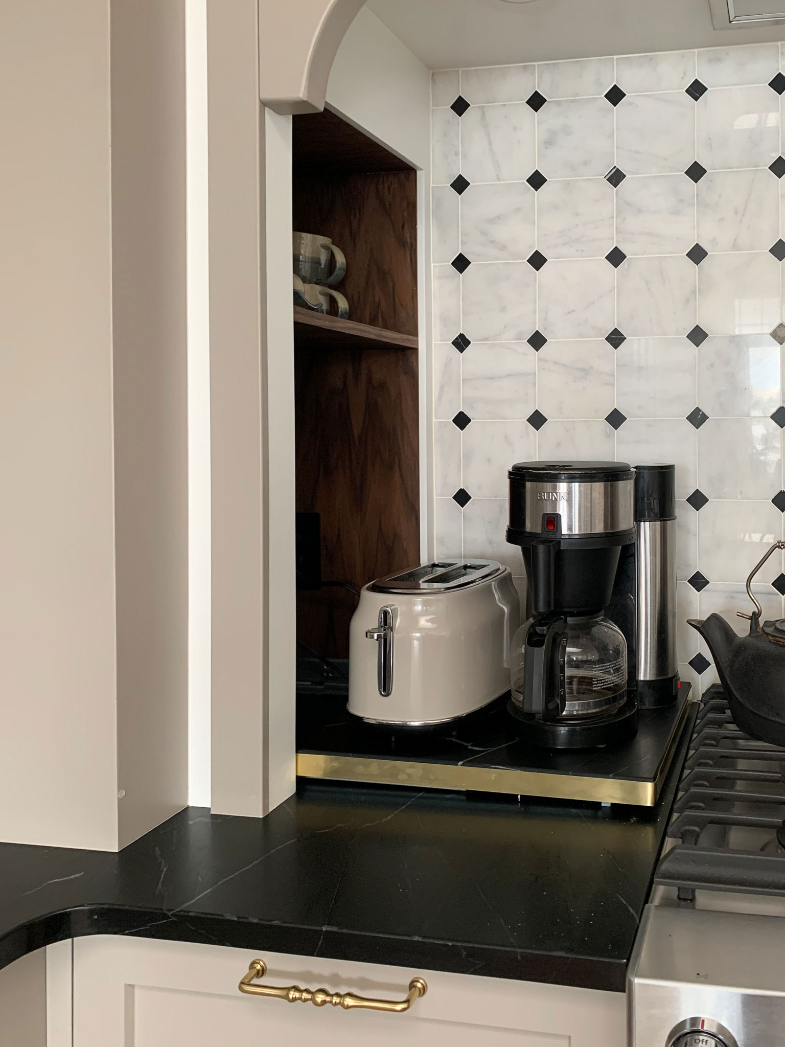 appliance tray pull out for coffee maker and toaster pulled out in a corner cabinet