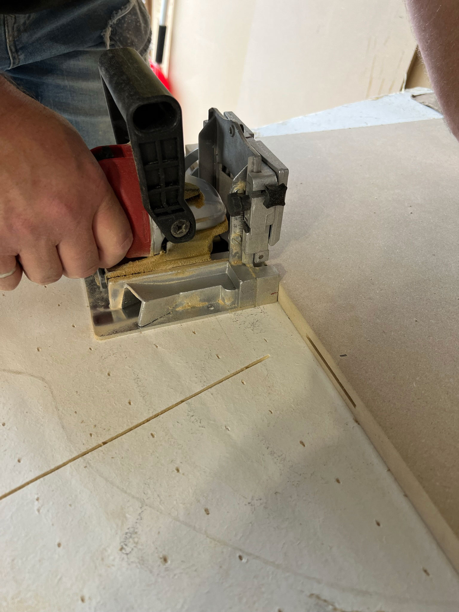 Buscuit joiner cutting holes for the buscuits in the side of MDF