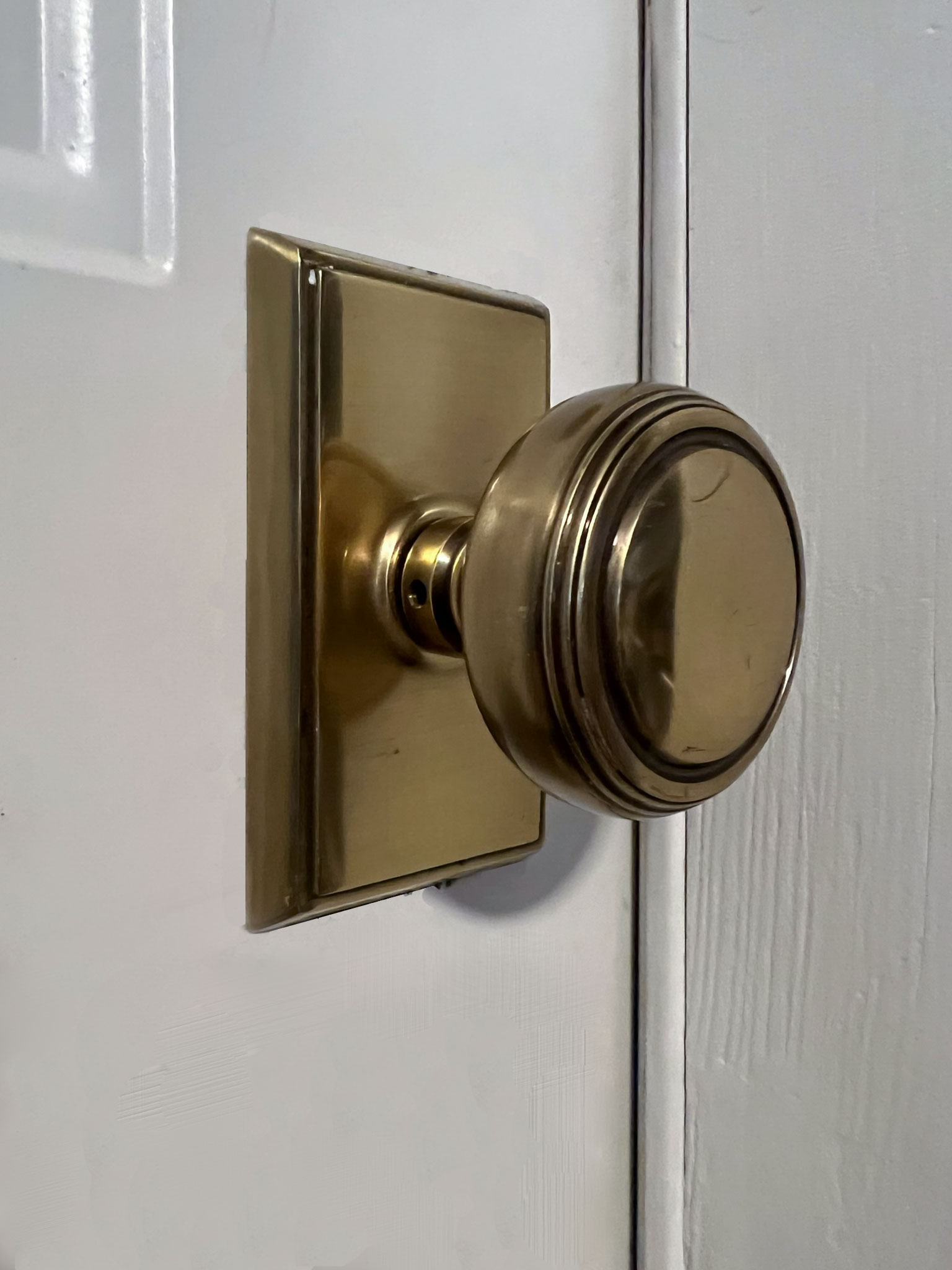 Brass emtek door knob in antique brass with a rectangular rosette