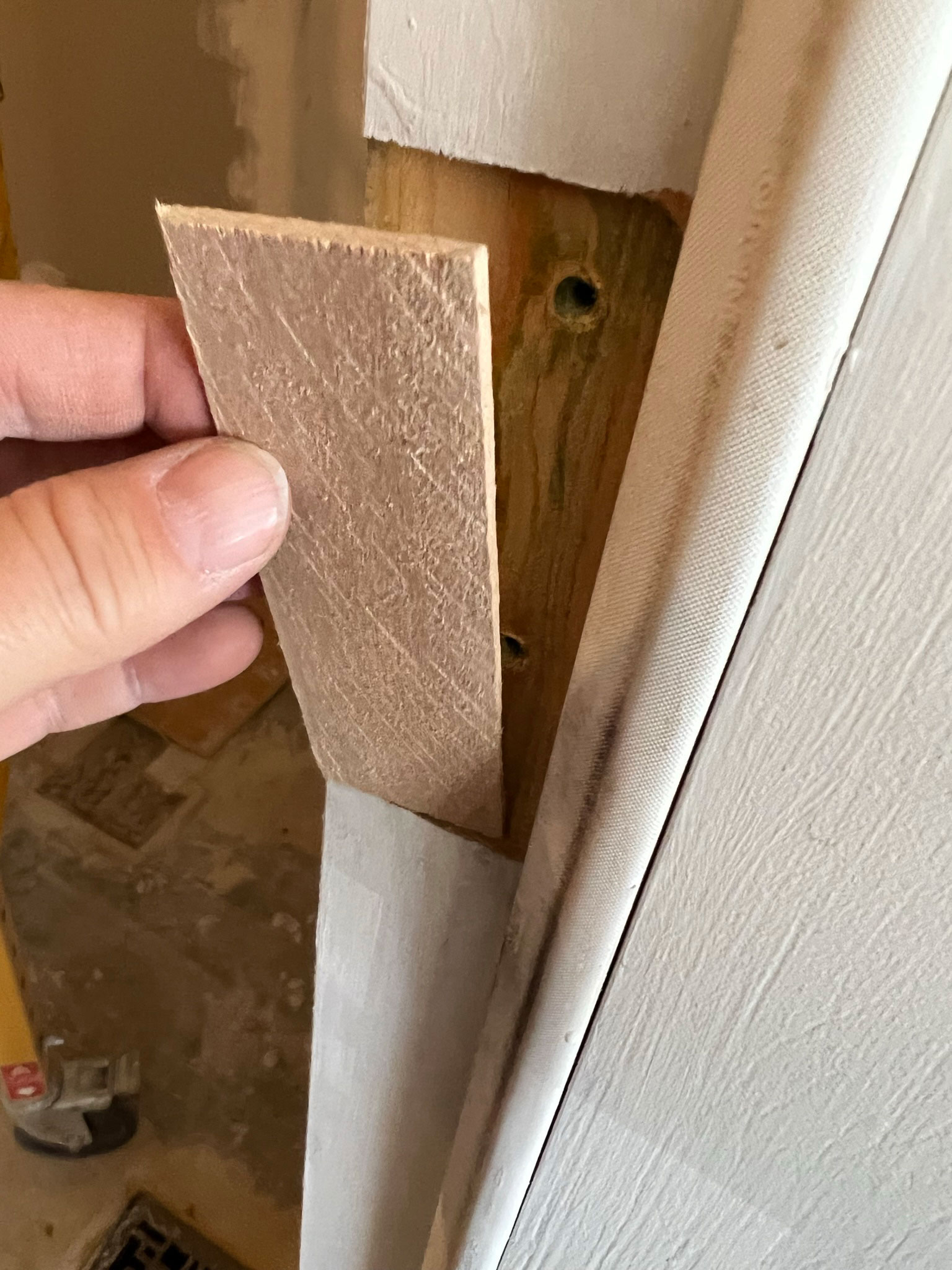 placing a thin piece of wood in the old hinge location
