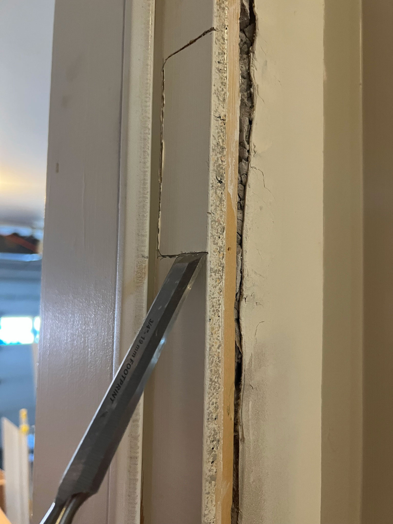 using a chisel to remove area from a door jam