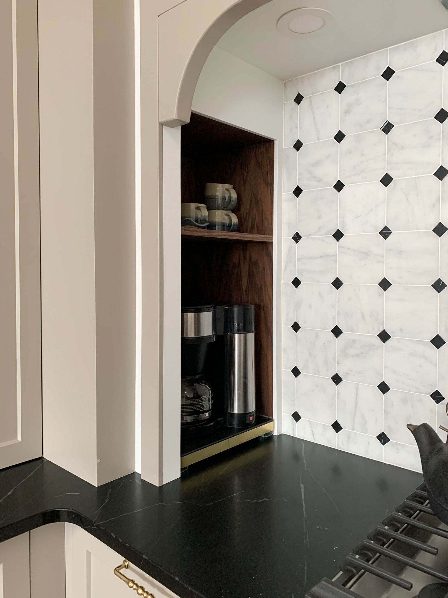 wood box installed at the countertop level in the corner containing a sliding shlef for appliances