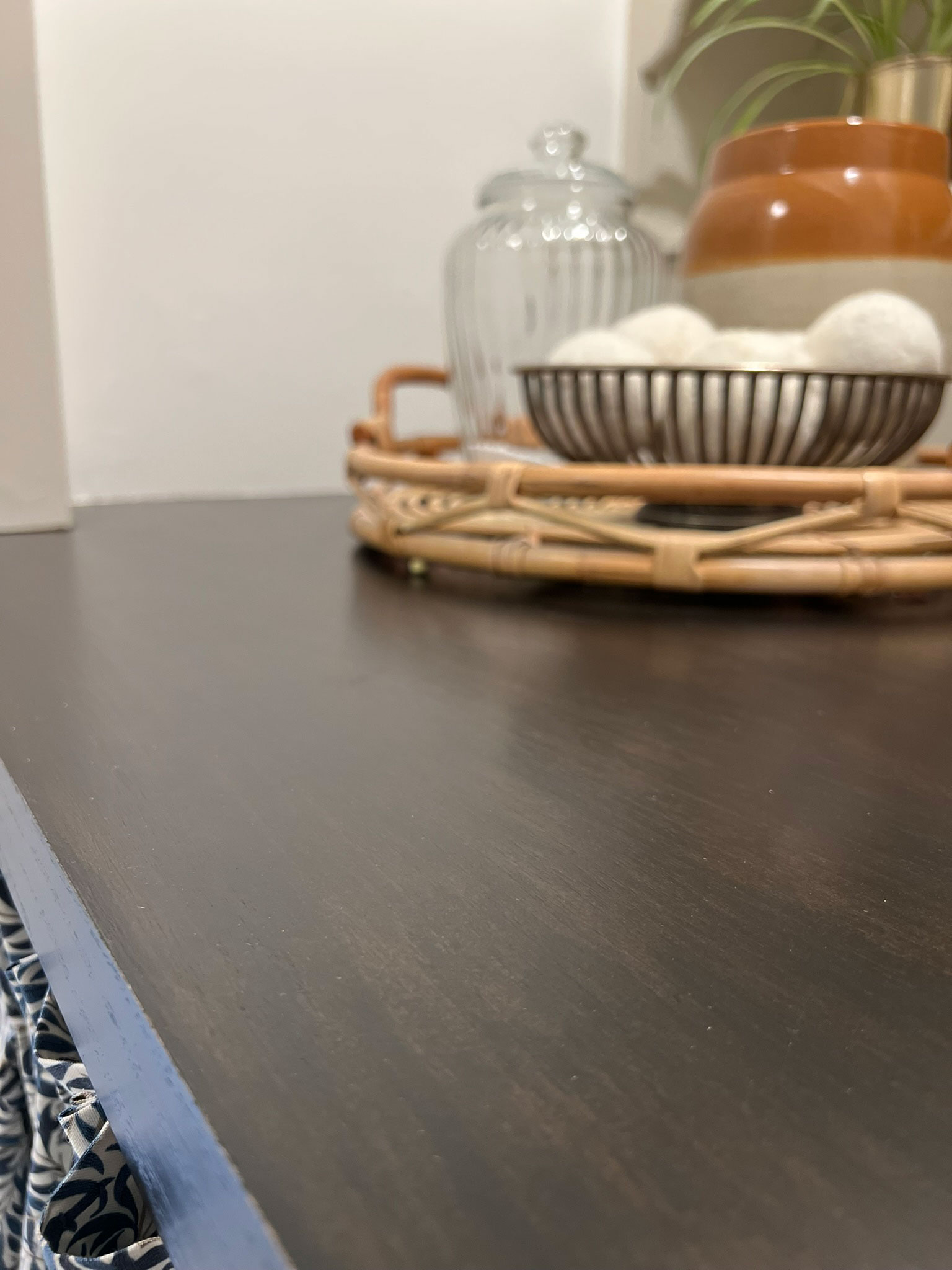 black stained wood DIY countertop close up with styling accessories in the background