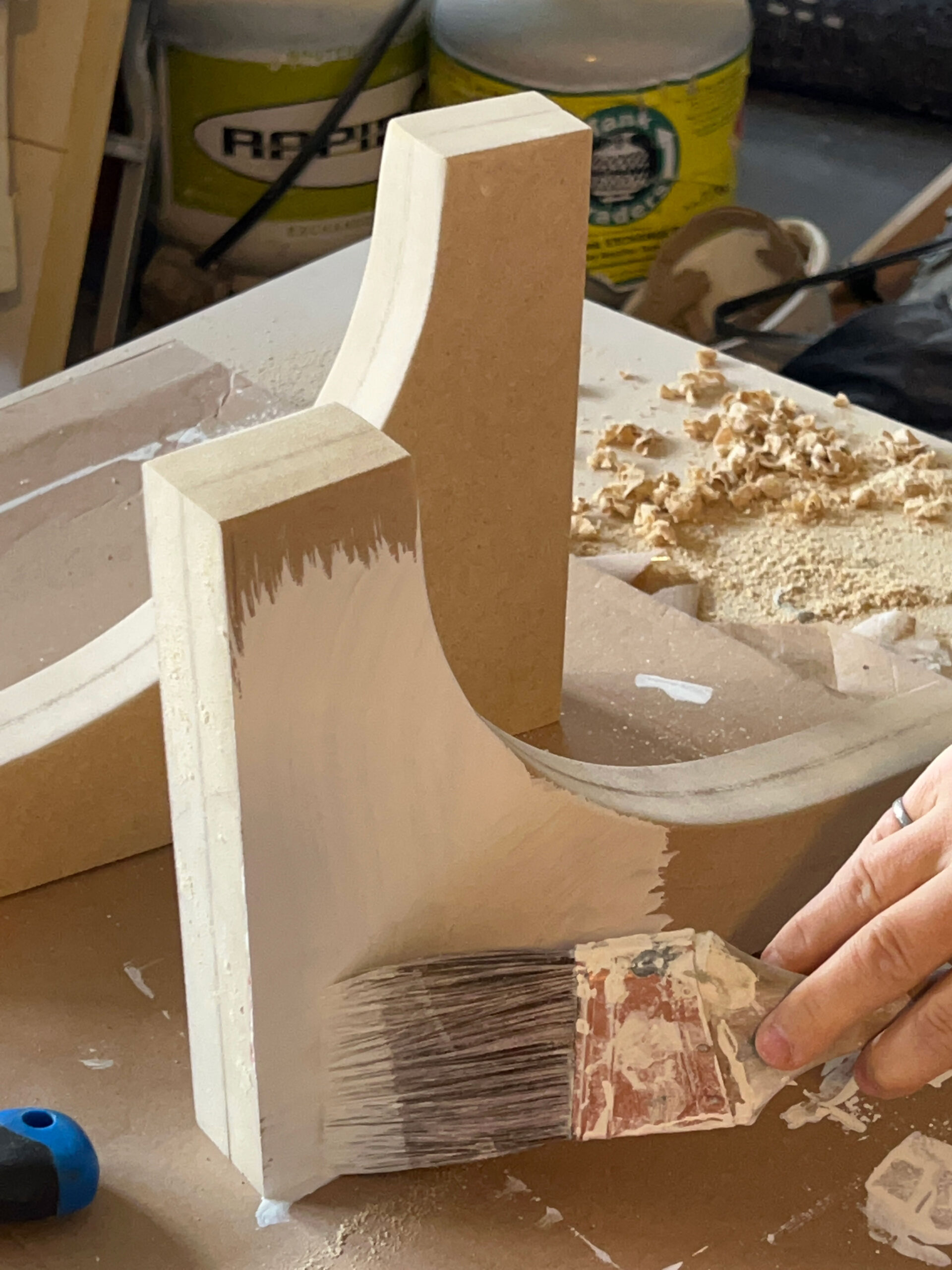 painting the corbels with a brush and primer
