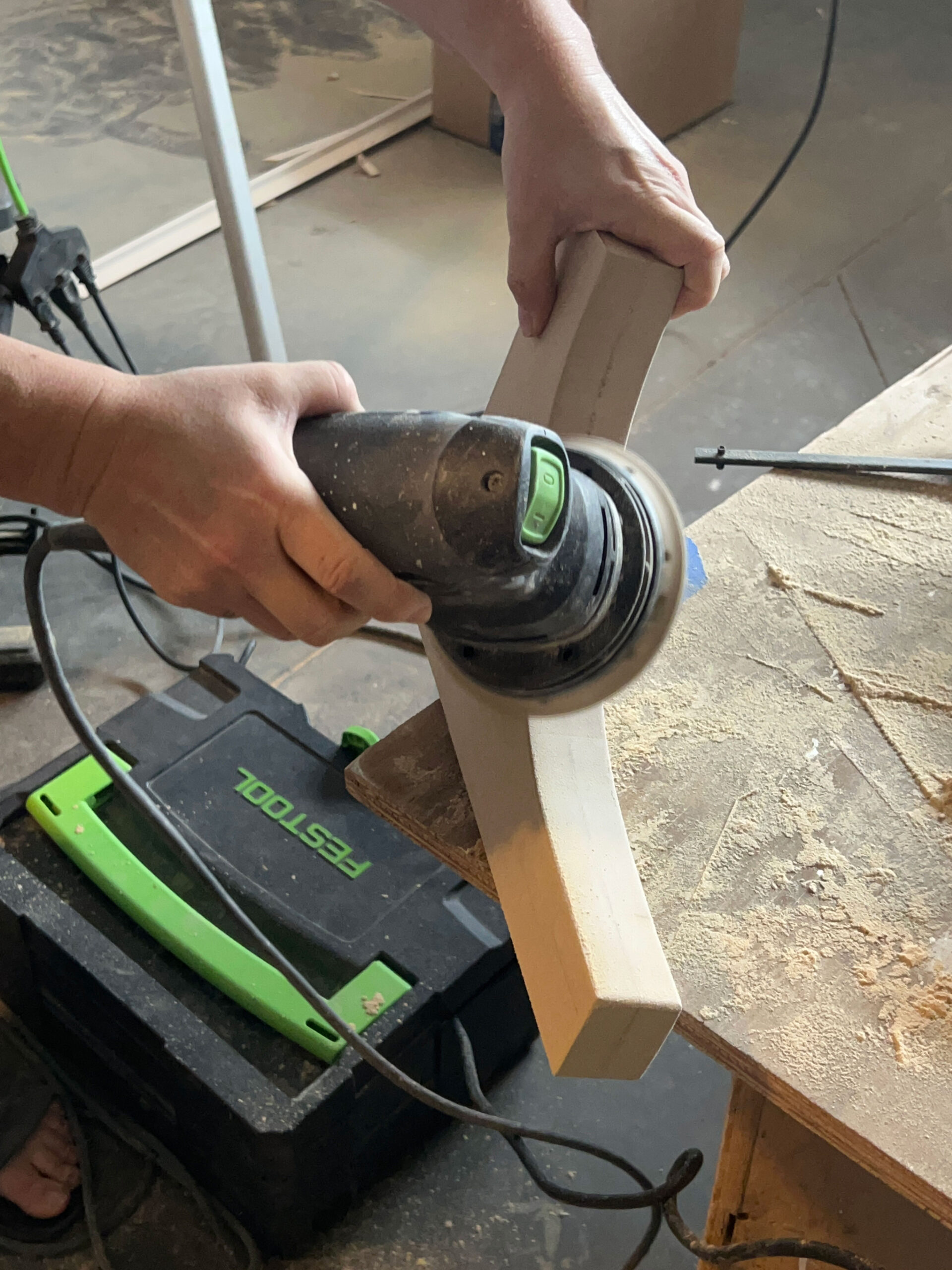 rounding out the edges of the DIY corbel with a palm sander