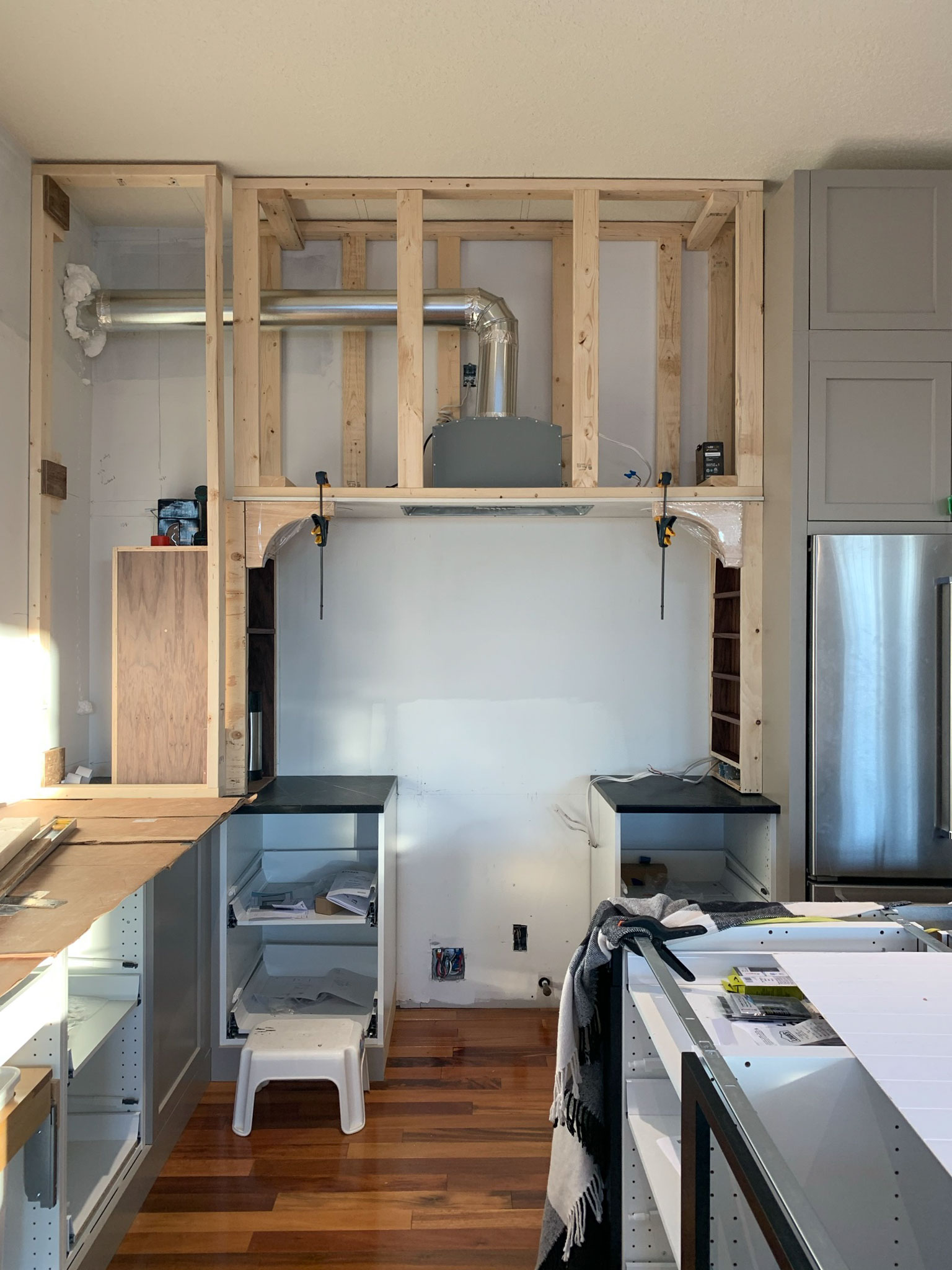 hood vent area under construction with rough framing in place on top of newly installed countertops