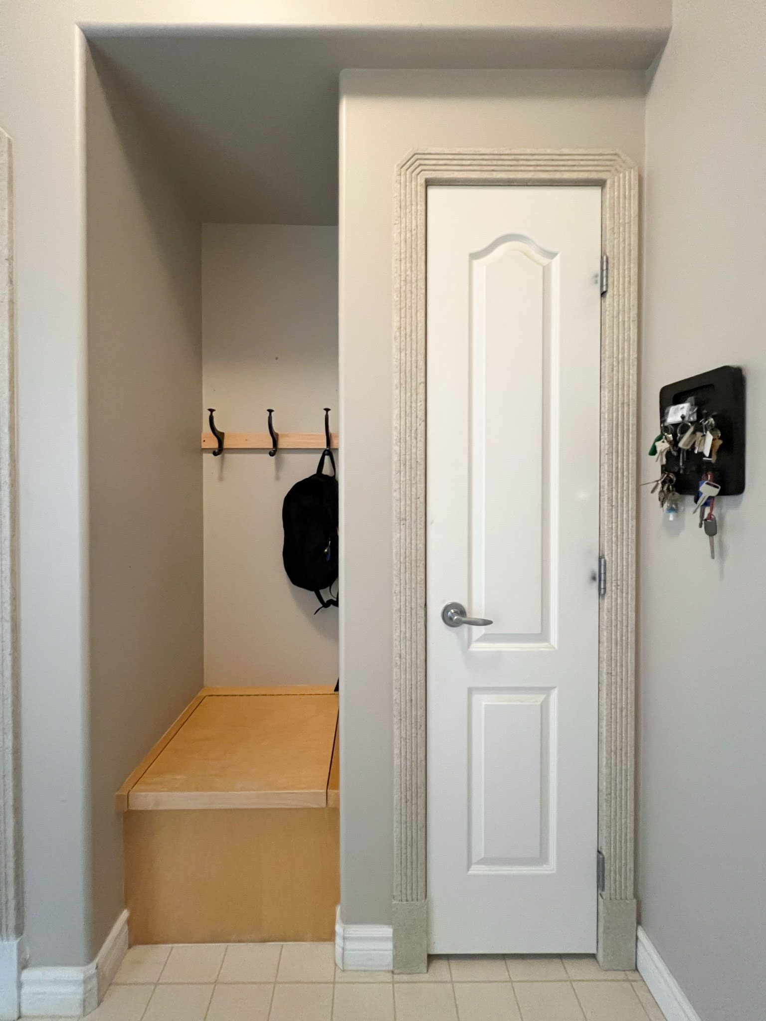 alcove with a skinny closet on one half and a skinny bnech on the other half