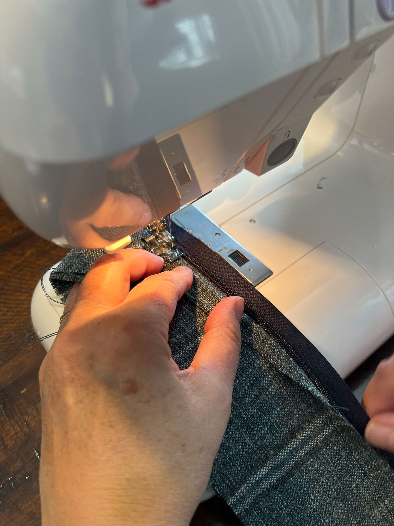 folding fabric back to sew along zipper edge
