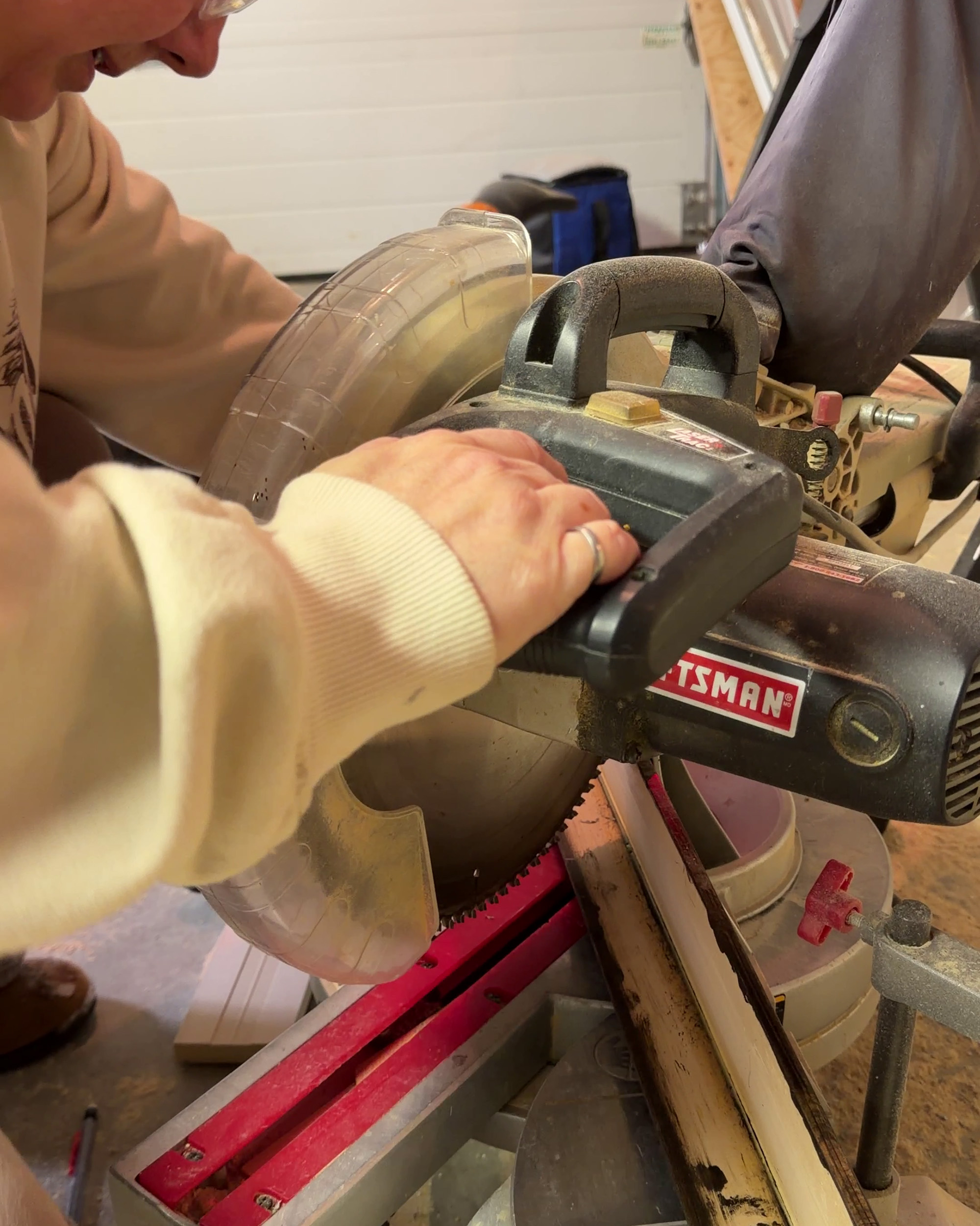 Cutting a piece of trim on a miter saw