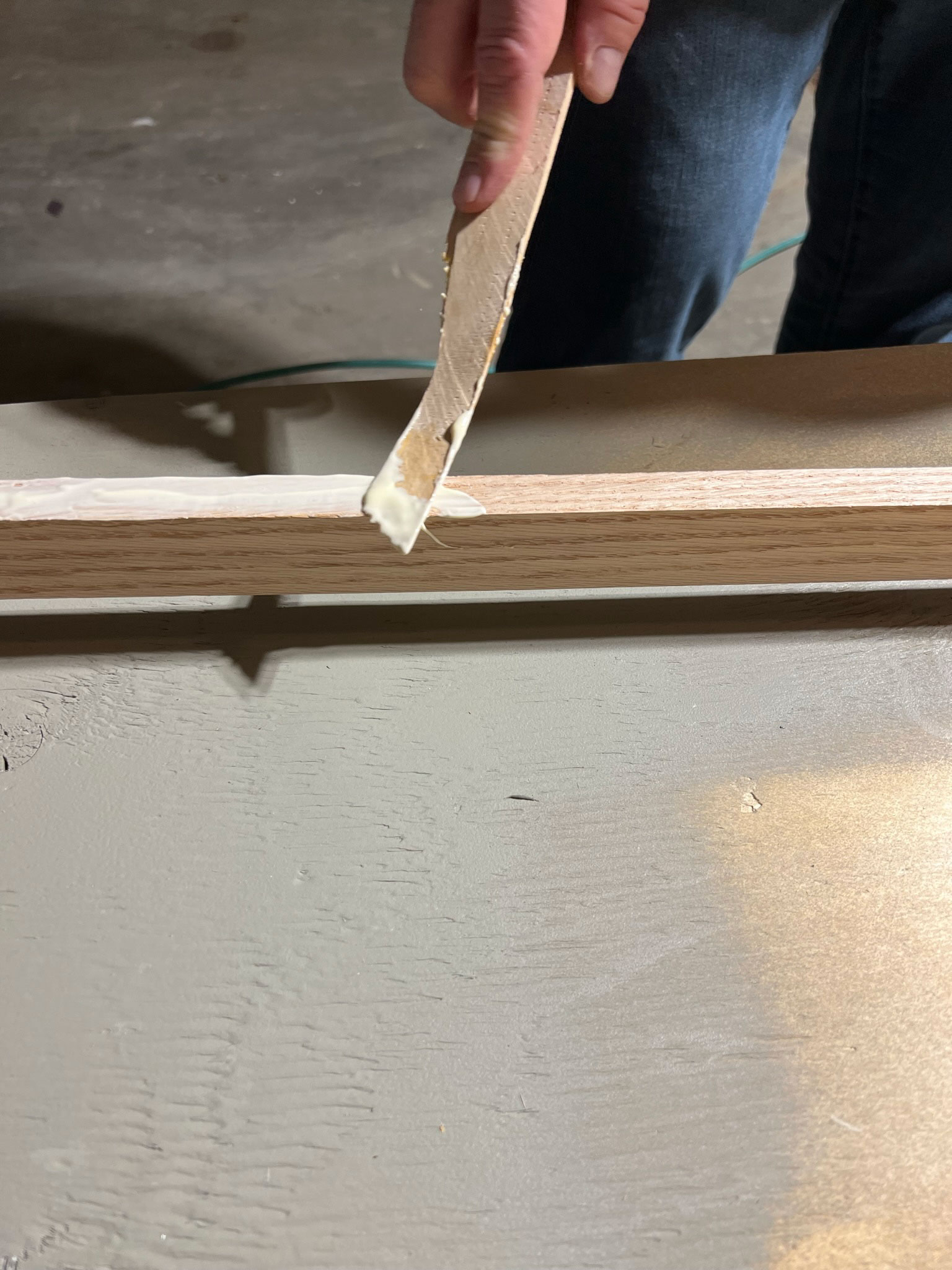 adding glue with a stick to the frame