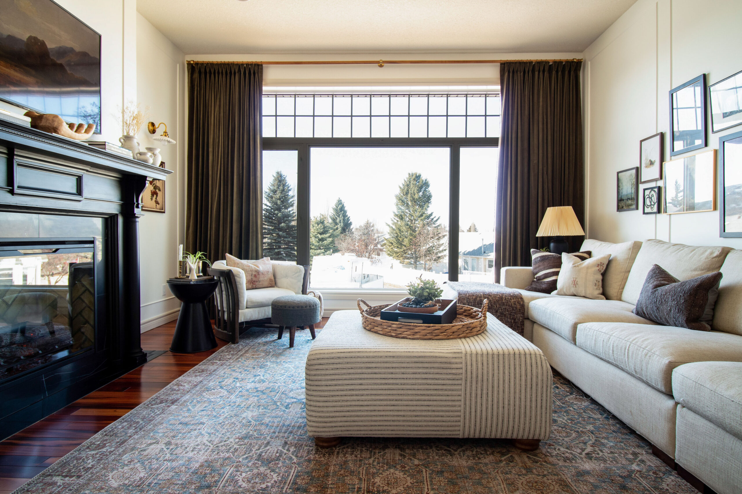 living room with large window and black fireplace