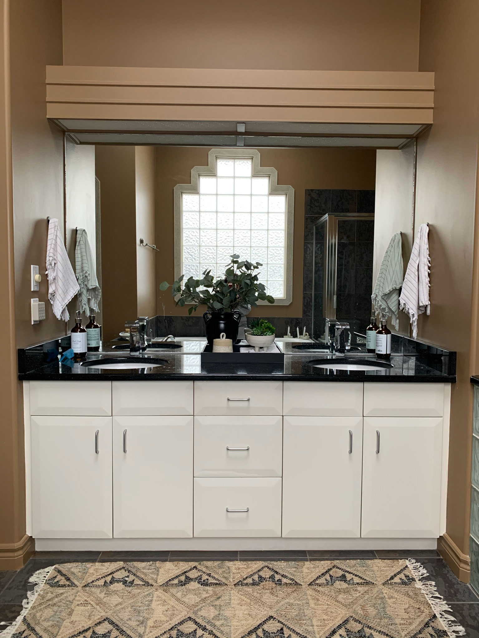 existing vanity with white cabinets and black countertops