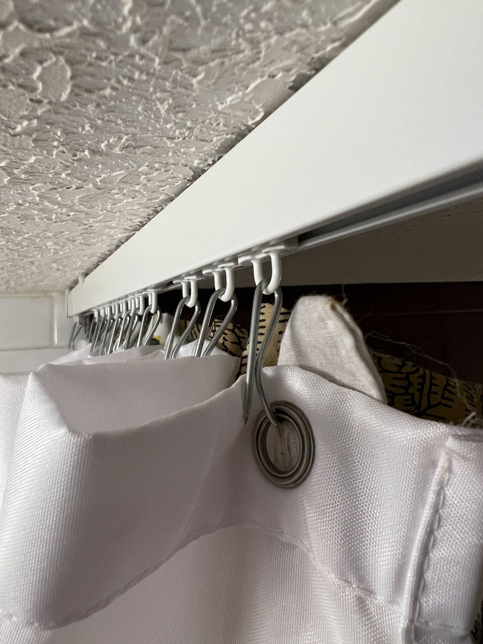 Using a Ceiling Curtain Track to Hang a Shower Curtain