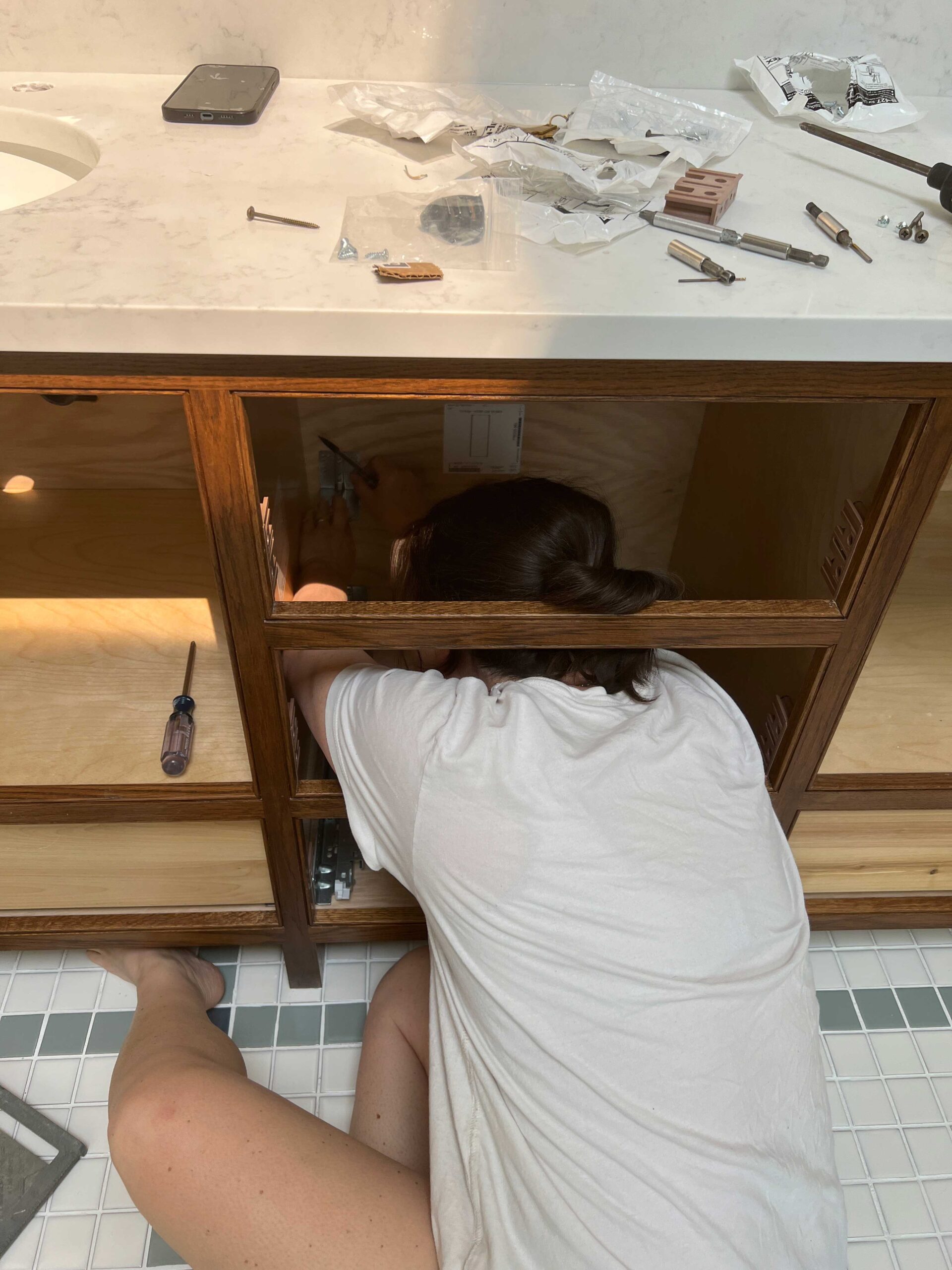 https://erinzubotdesign.com/wp-content/uploads/2023/06/installing-drawer-slides-with-cabinet-in-place-scaled.jpg