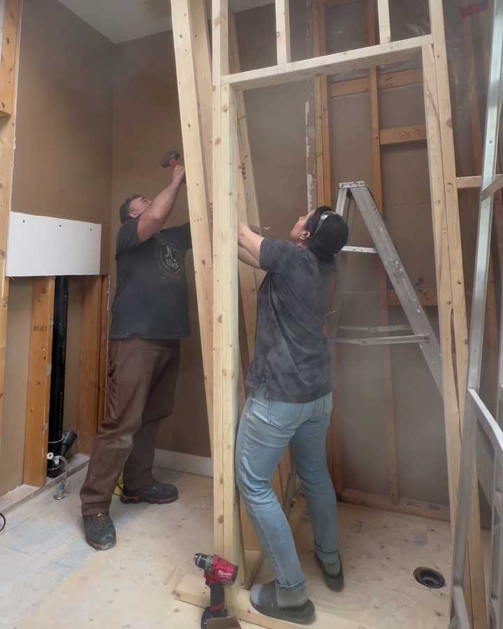 two people adding walls during the diy bathroom makeover