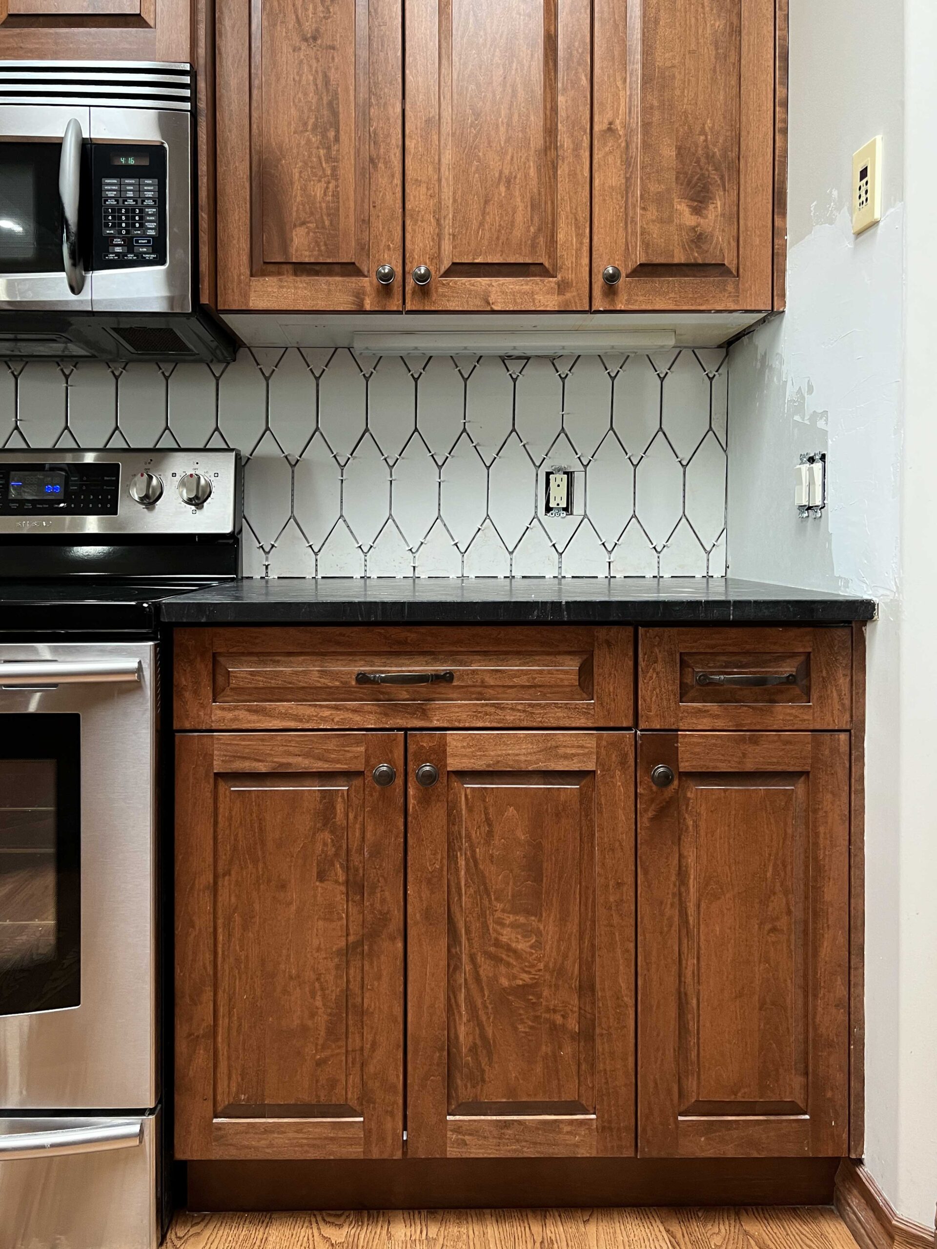 https://erinzubotdesign.com/wp-content/uploads/2023/08/backsplash-after-tiling-stove-wall-with-spacers-scaled.jpg