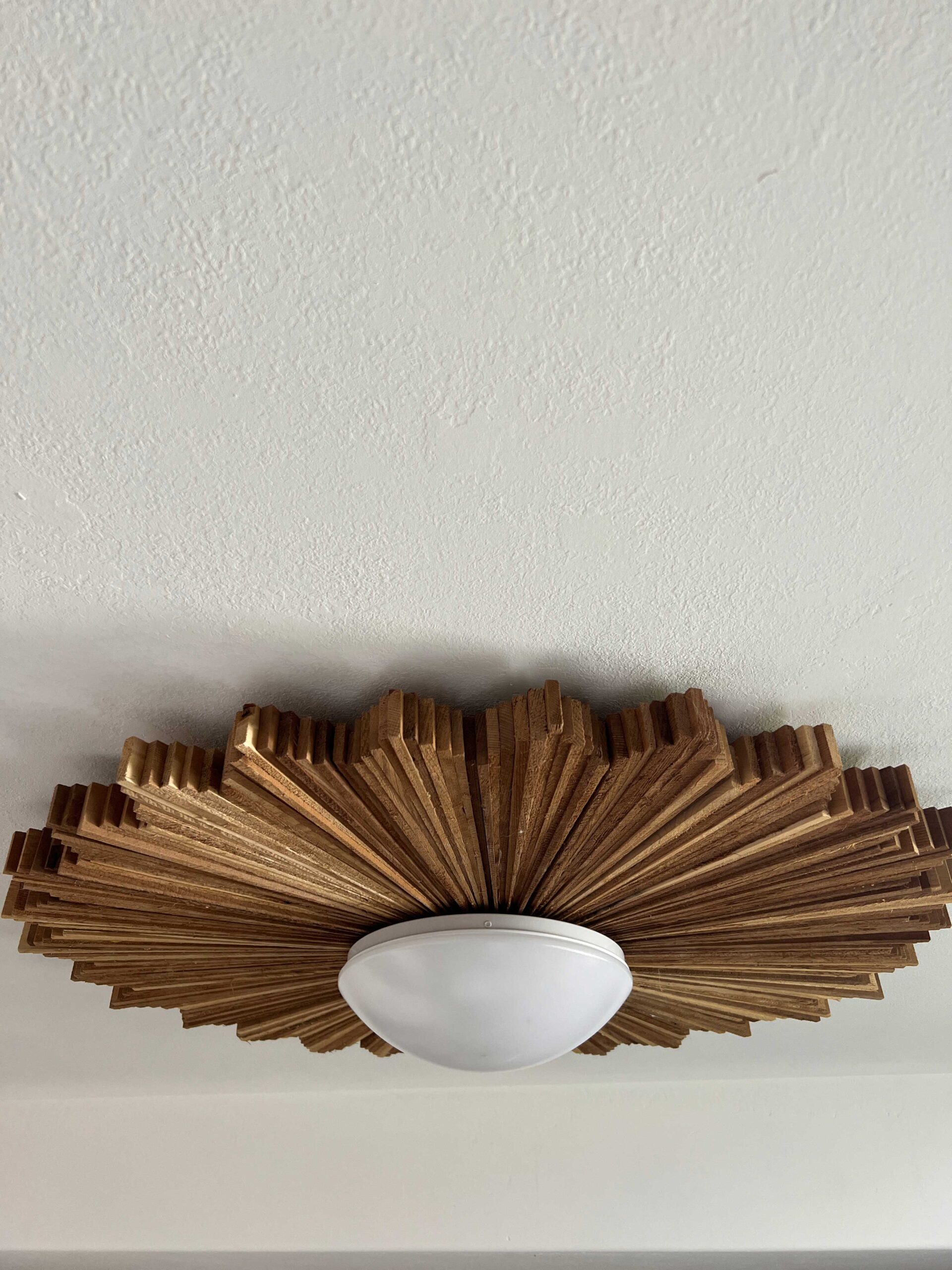 cedar shim starburst light fixture on a textured ceiling