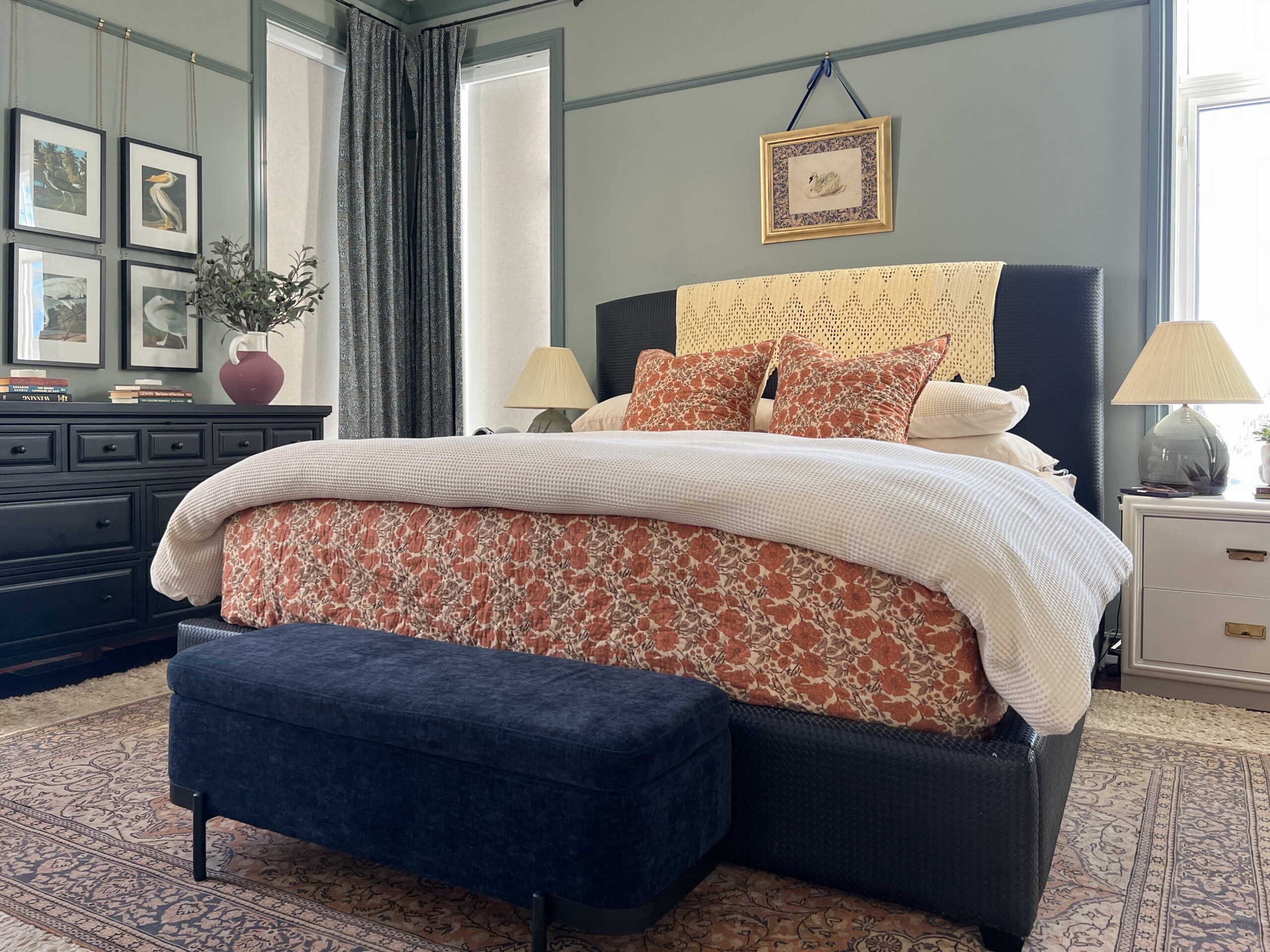 bedroom with white waffel weave blaket on bed and red floral bedspread