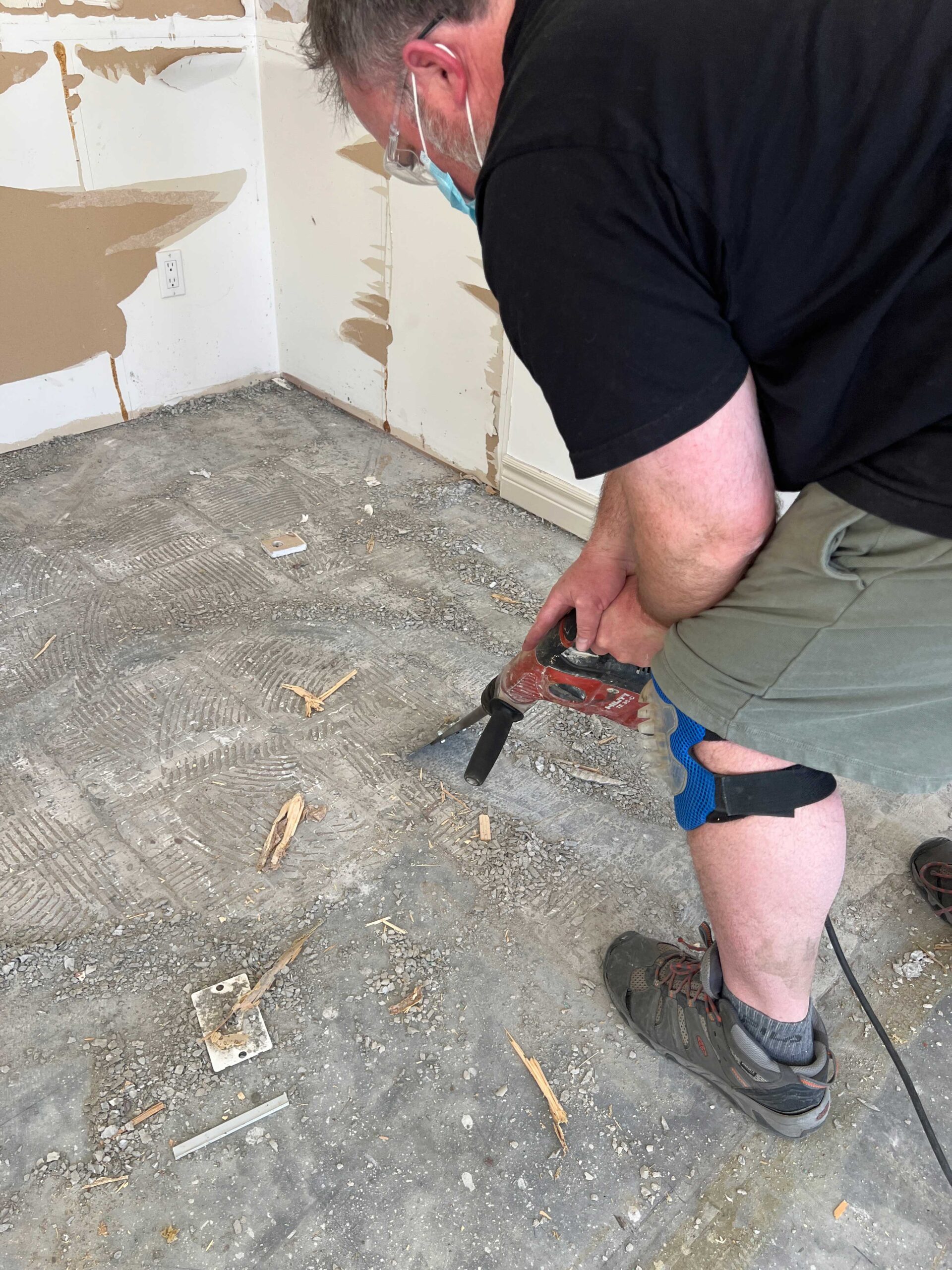 using a tile removal bit to scrape old mortar