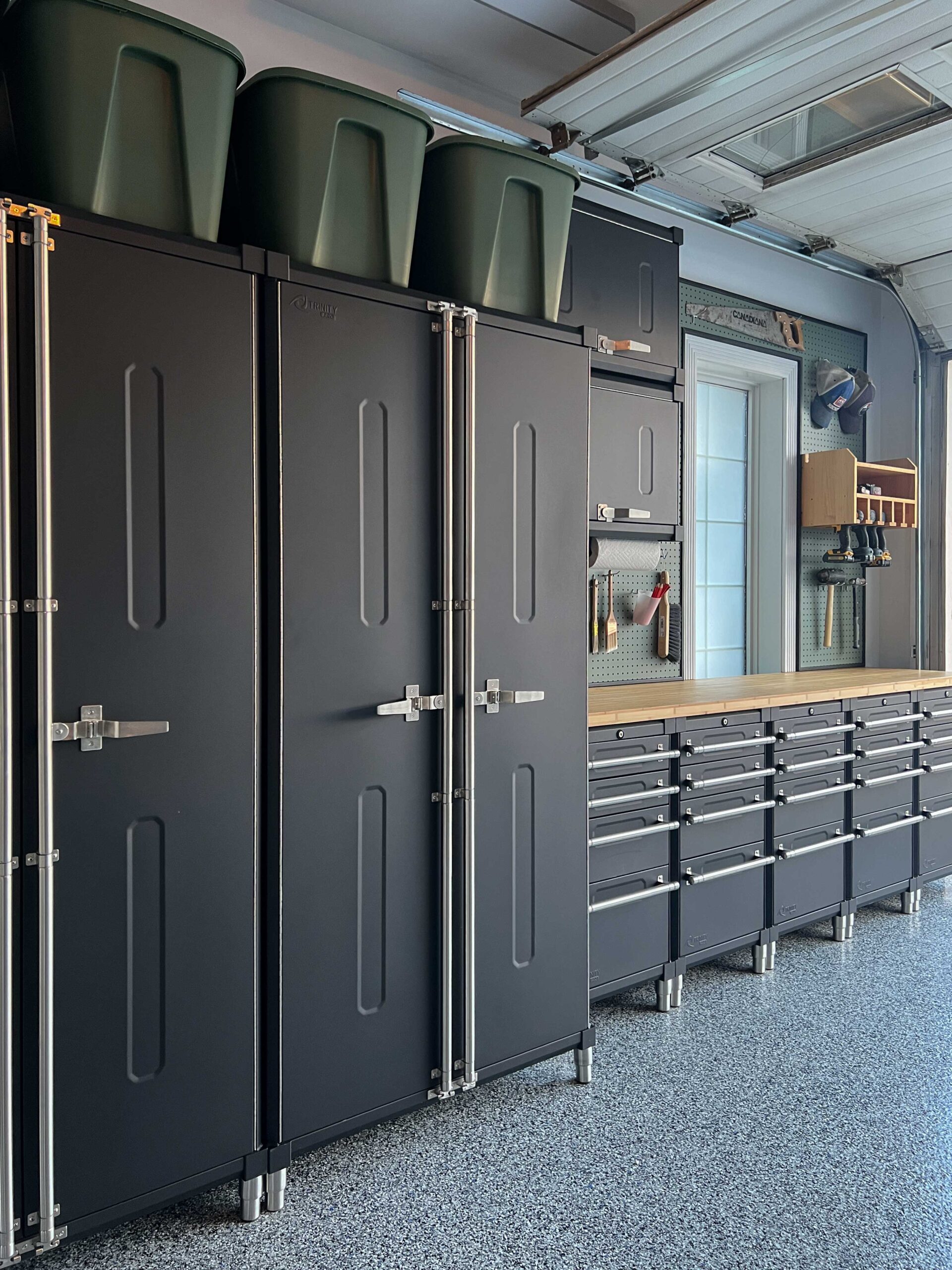 Black Garage cabinets with green pegboard