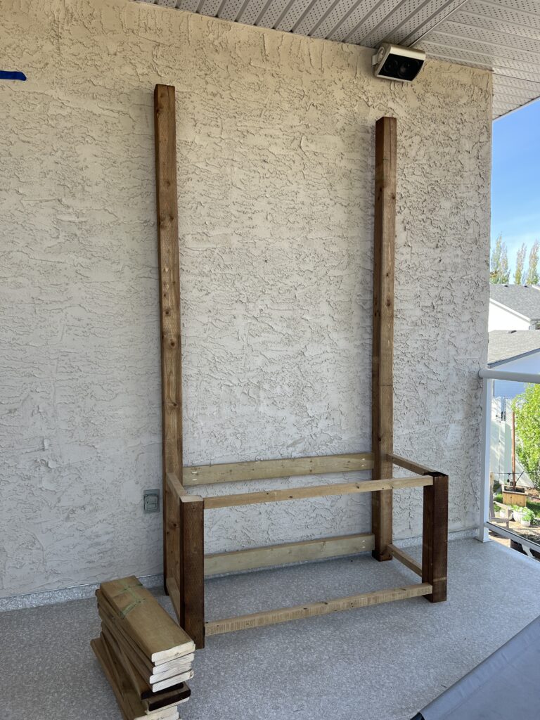 The front frame pieces are screwed to the back frame pieces, making a box with 2 long posts.