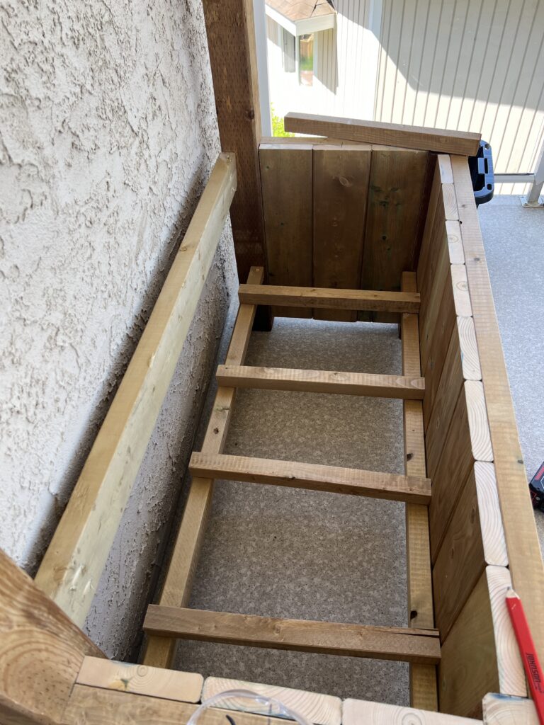 Pieces of 2x2s are attached to the frame to create a secure bottom of the planter.