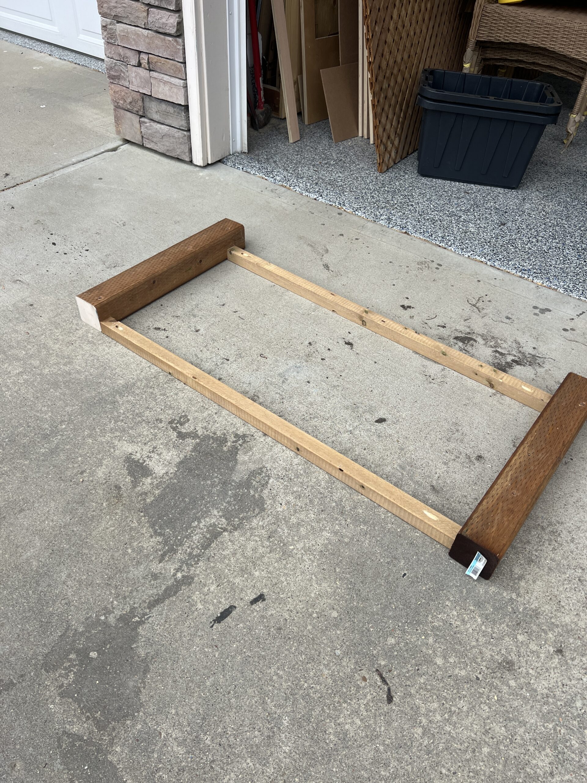 Two 2x2 boards are attached to two 4x4 boards to make the front frame of the planter.