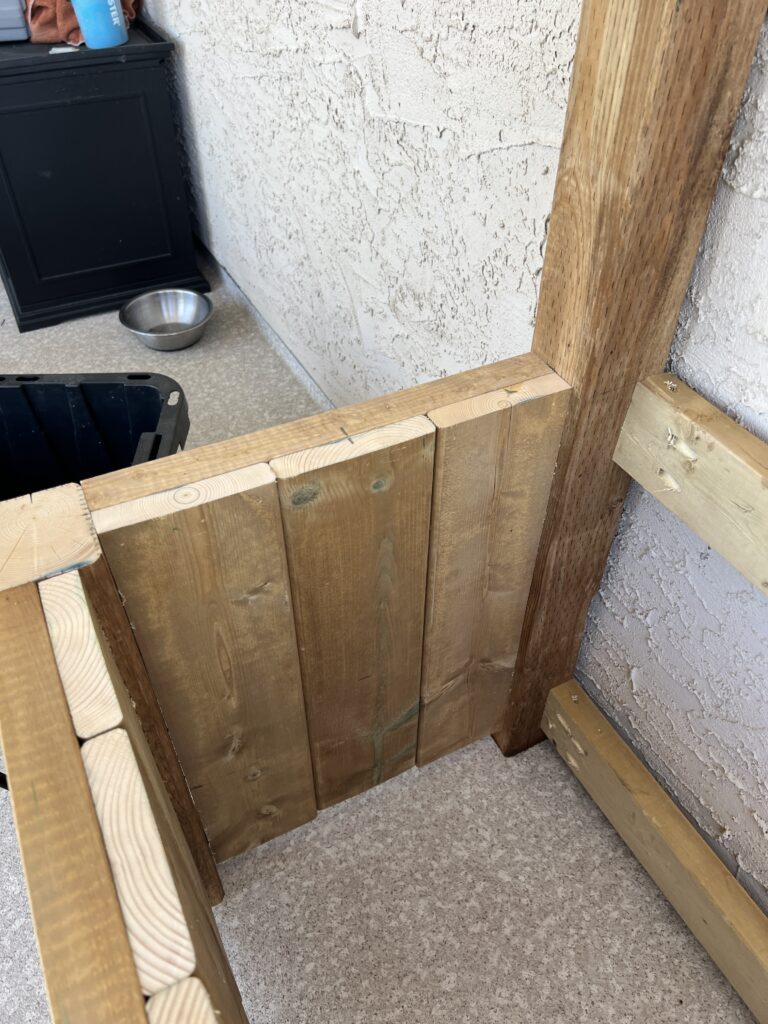 Deck boards are attached to the inside of the planter frame.