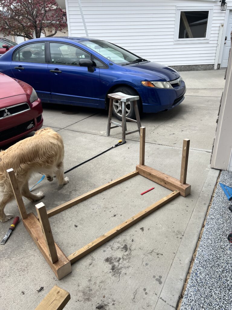 Four 2x2s are attached to the front frame piece to start to create a box shape.