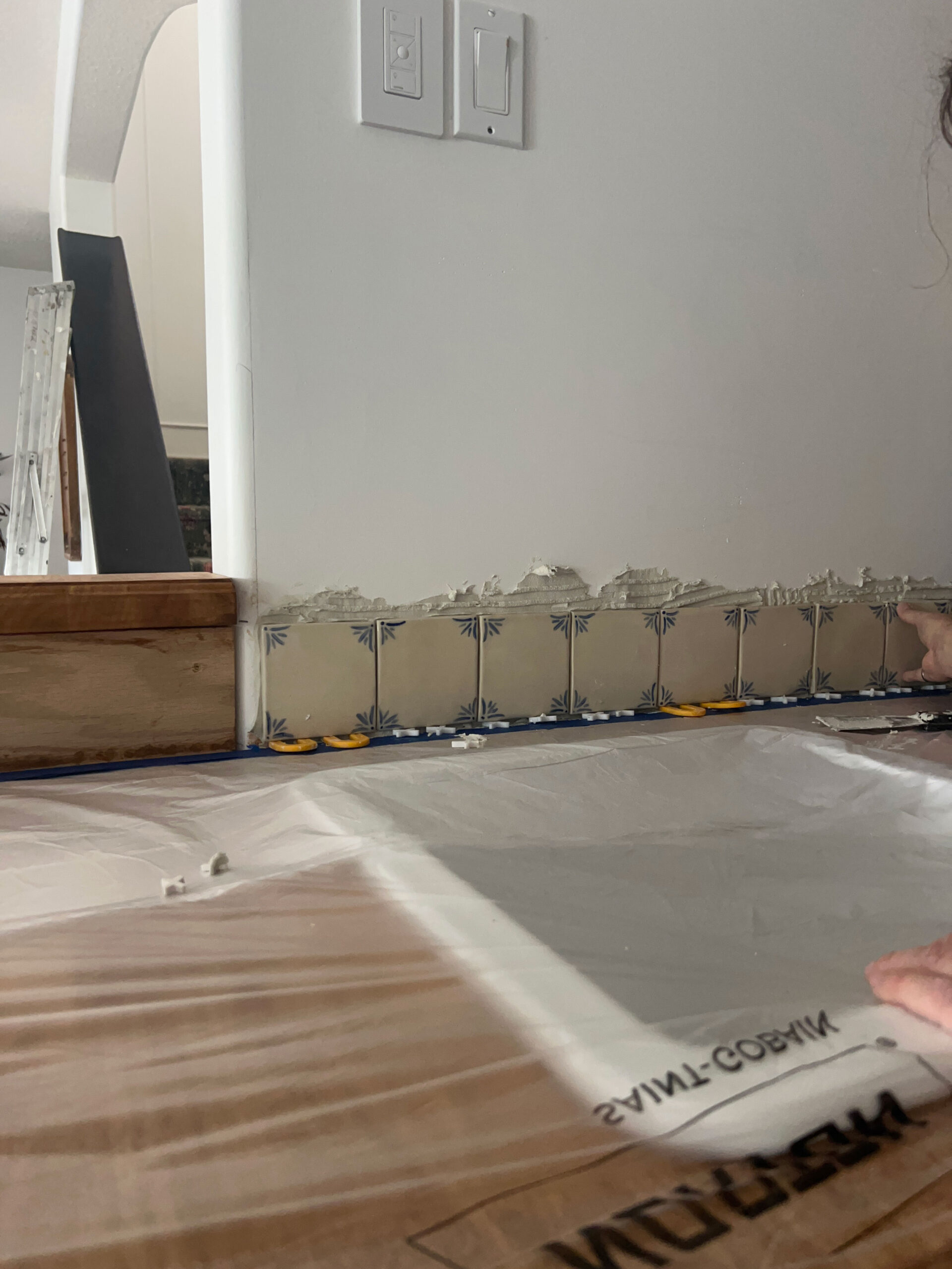 bottom row of tile installed on the wall