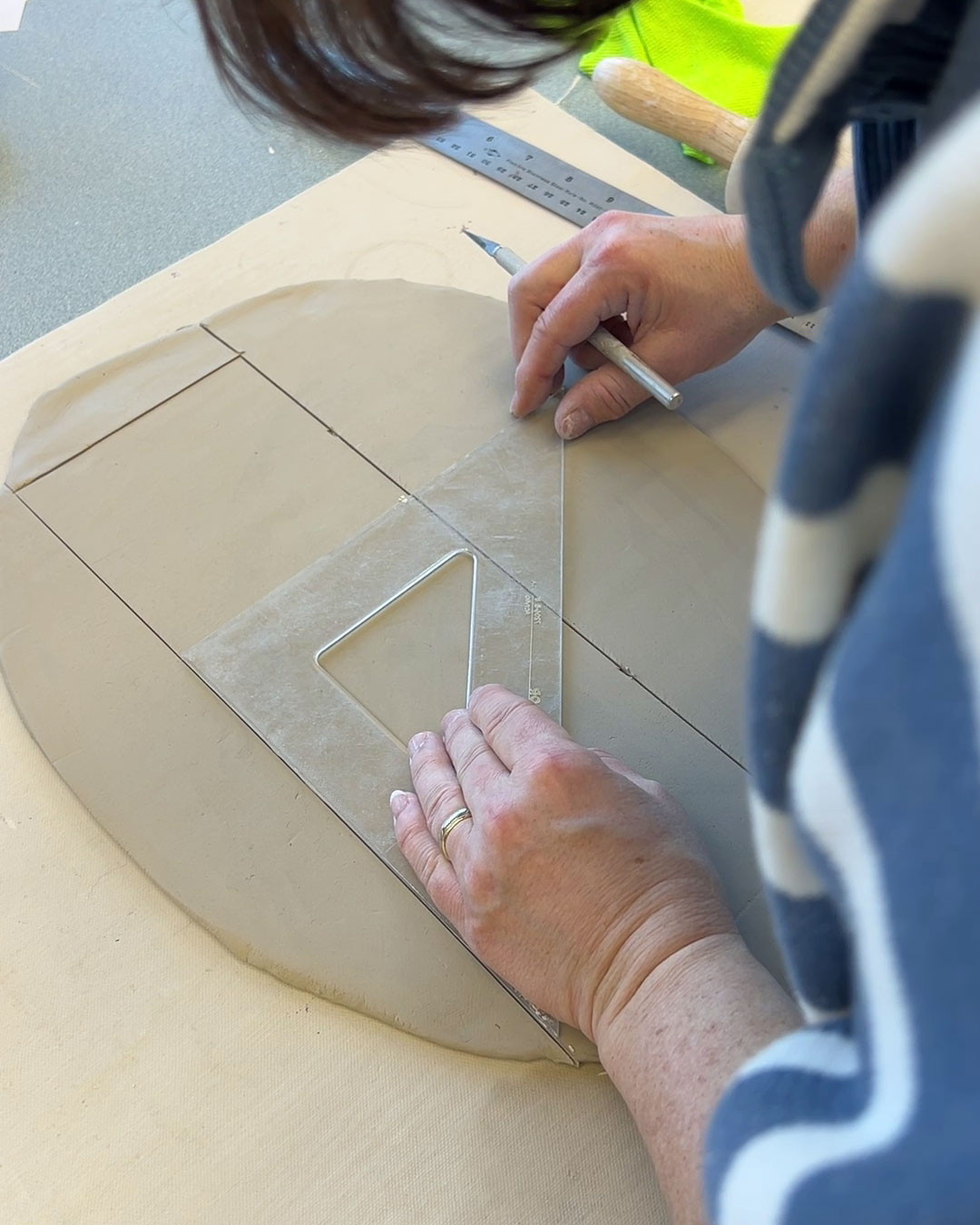 using a sqaure to cut tile out of rolled out clay