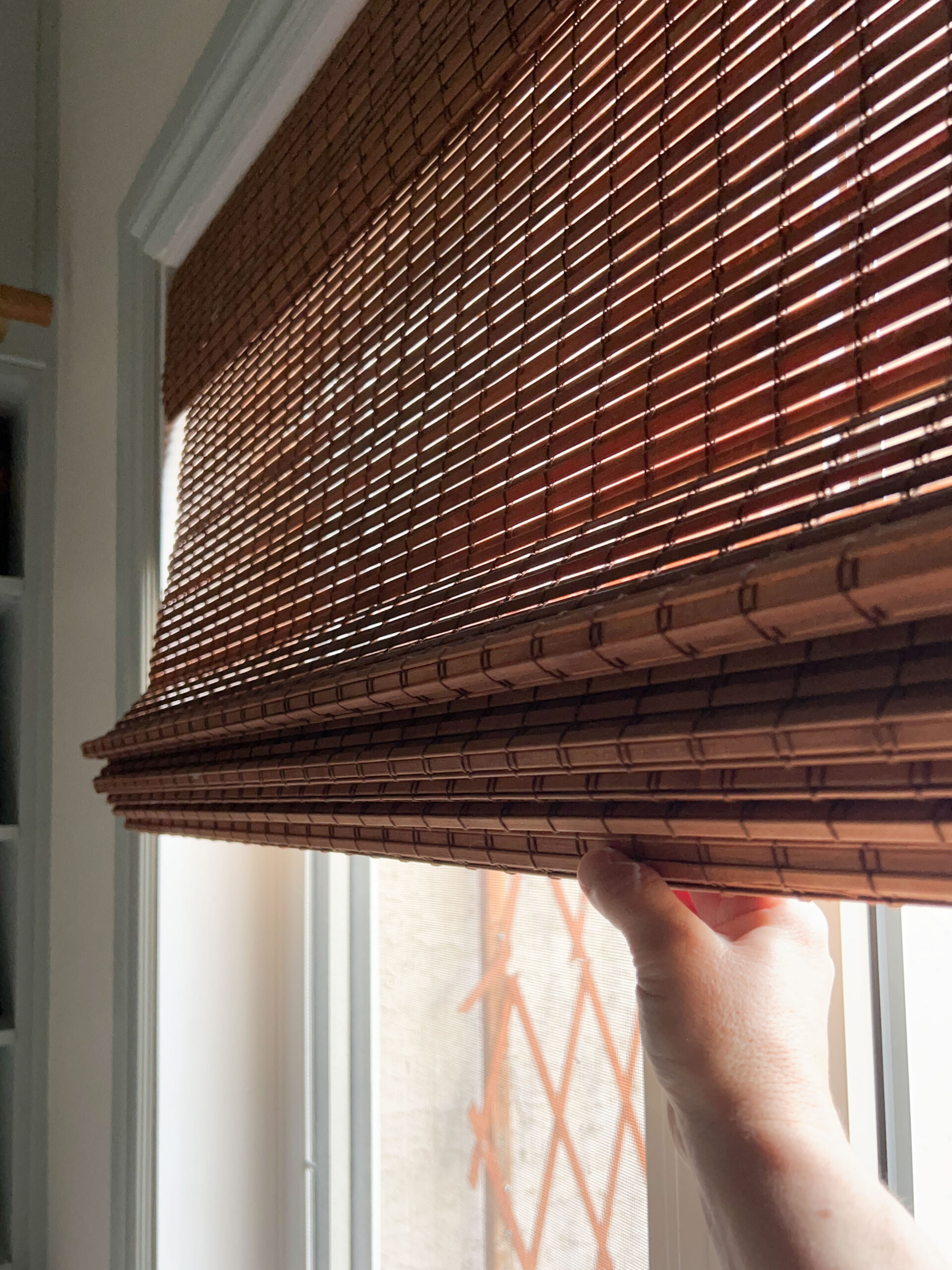 woven blinds being pulled down