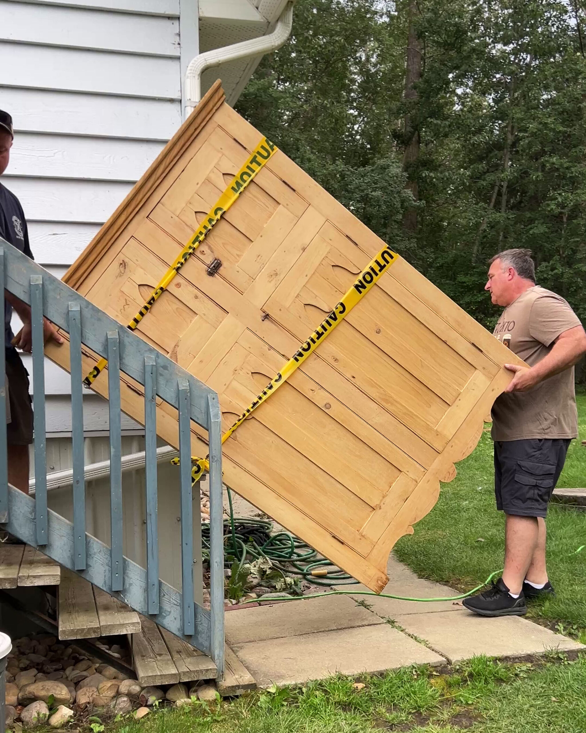 carrying an armoire up some stairs