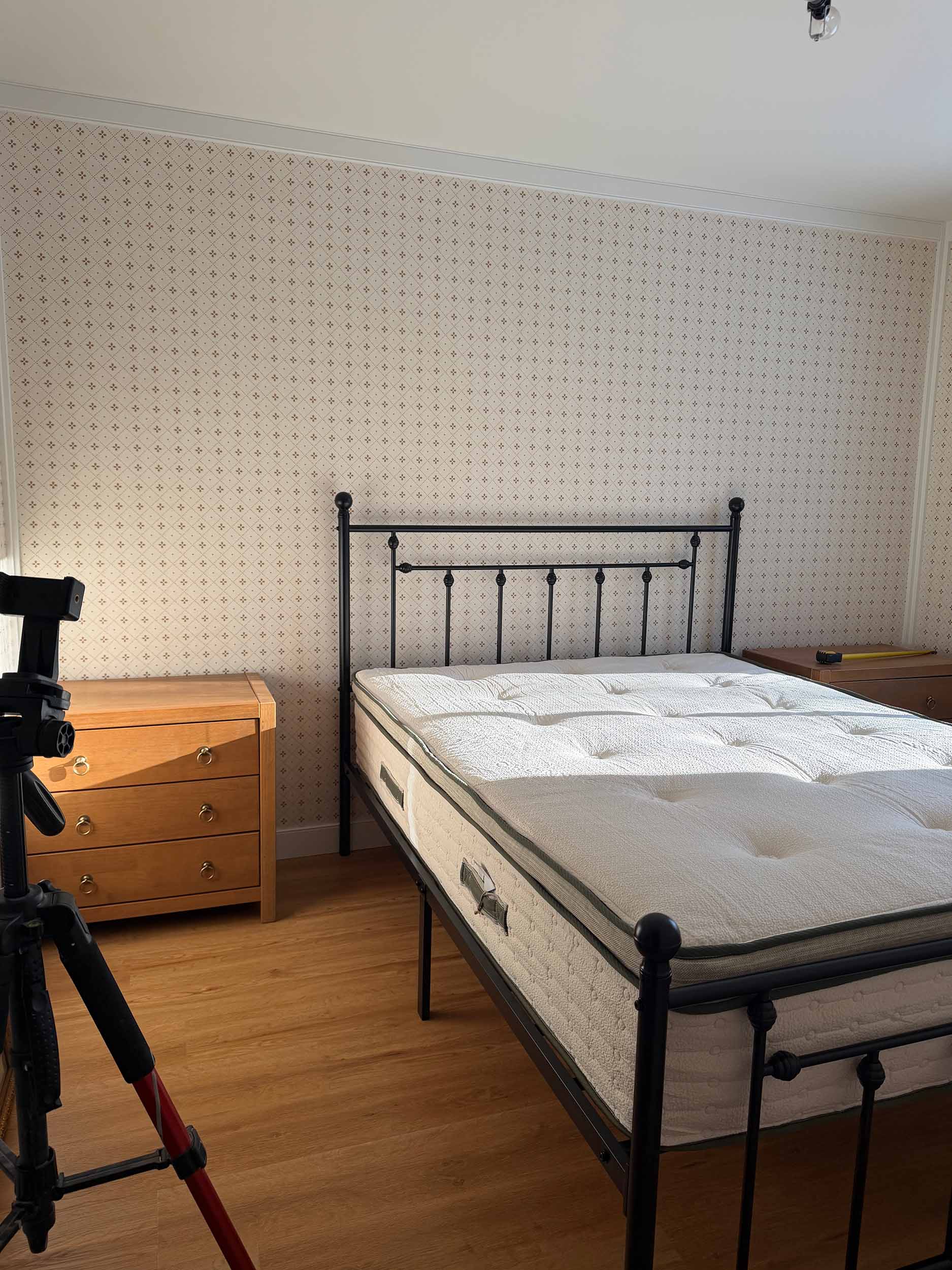 iron bed in a room with wood nightstands