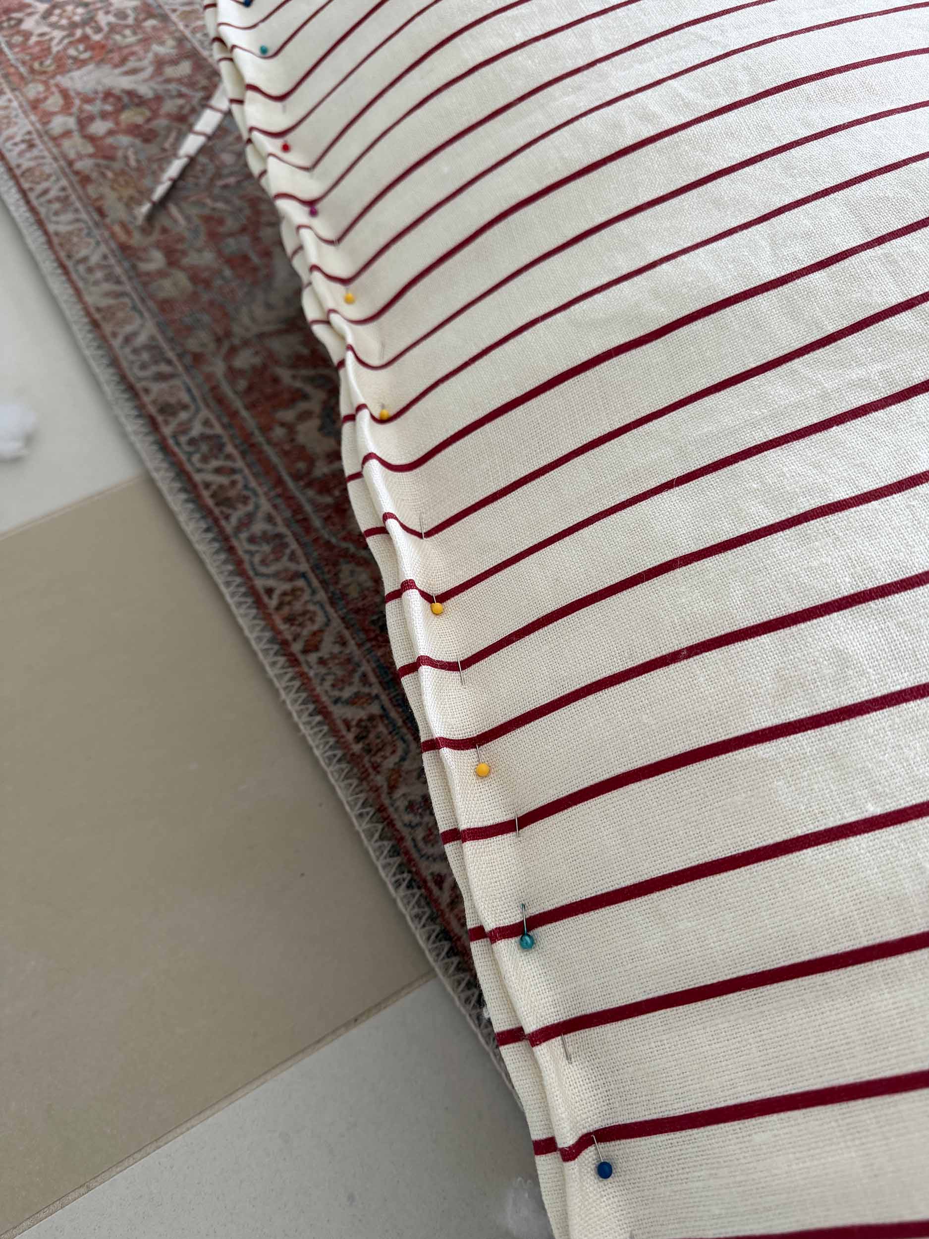 bottom seam of the headboard pillow pinned together