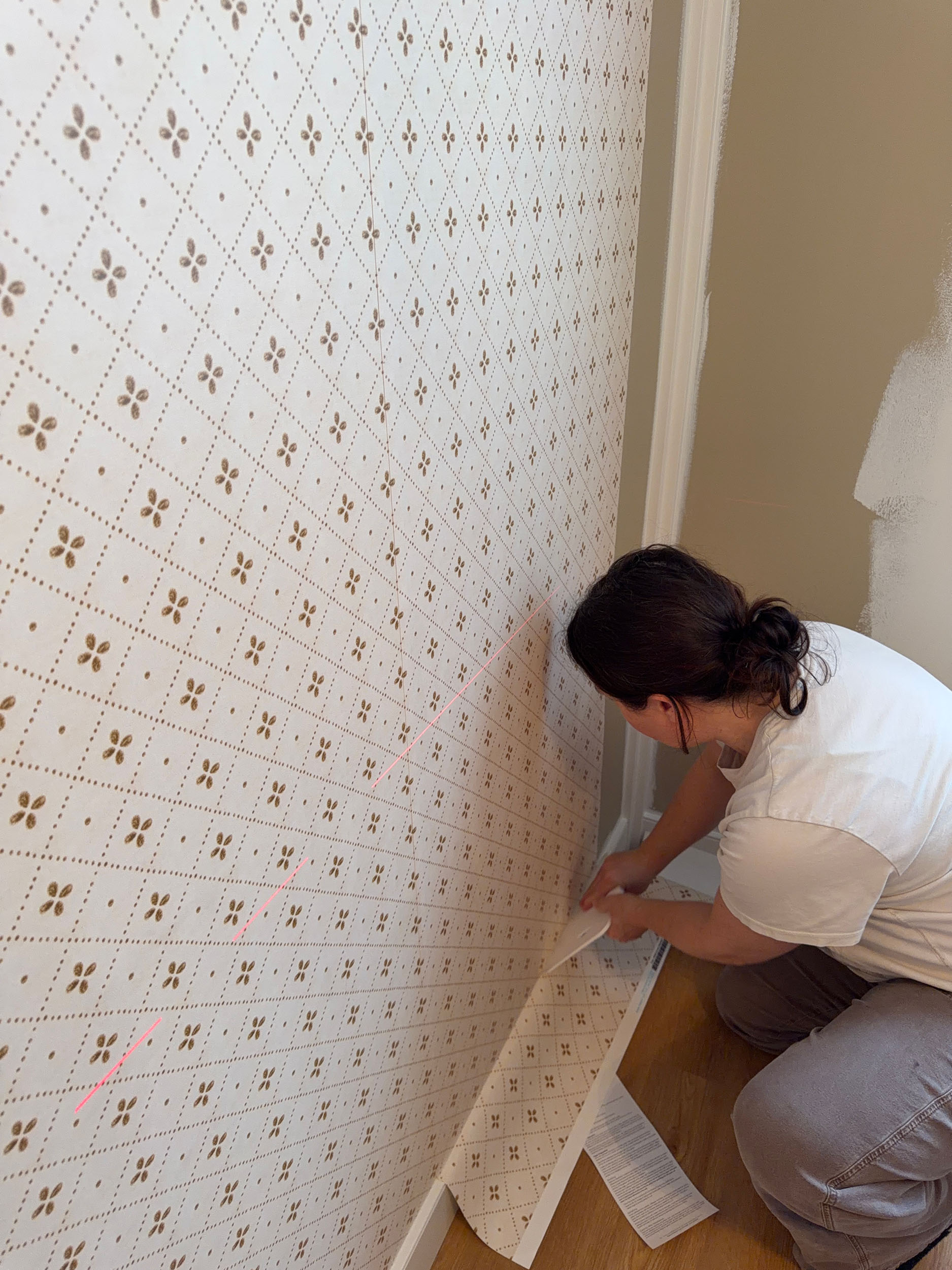 woman installing wallpaper