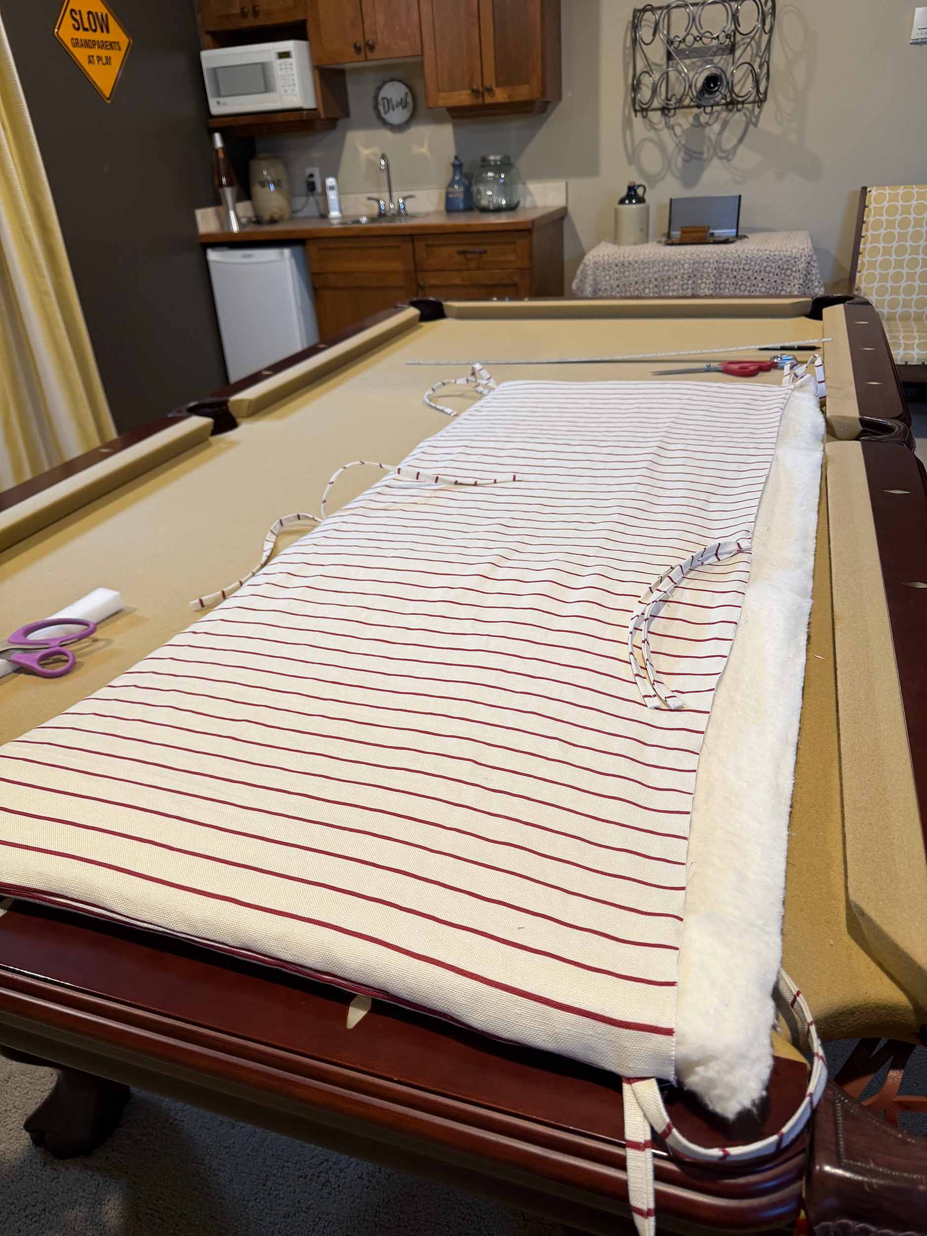 headboard pillow with some foam in and the bottom seam open