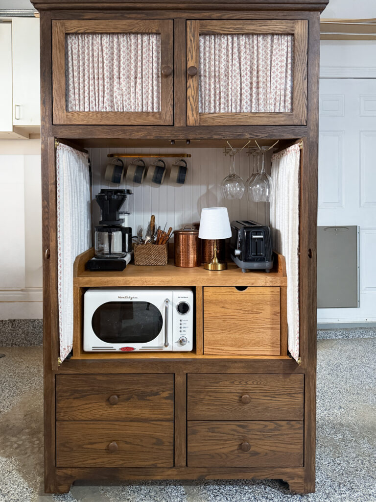 Finished DIY coffee bar with space for a microwave, coffee mugs, a toaster, and a coffee maker.