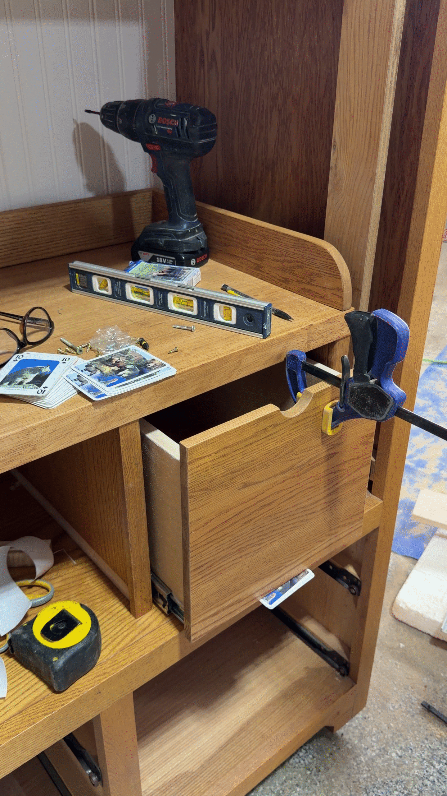 Drawer front being installed and clamped in place.