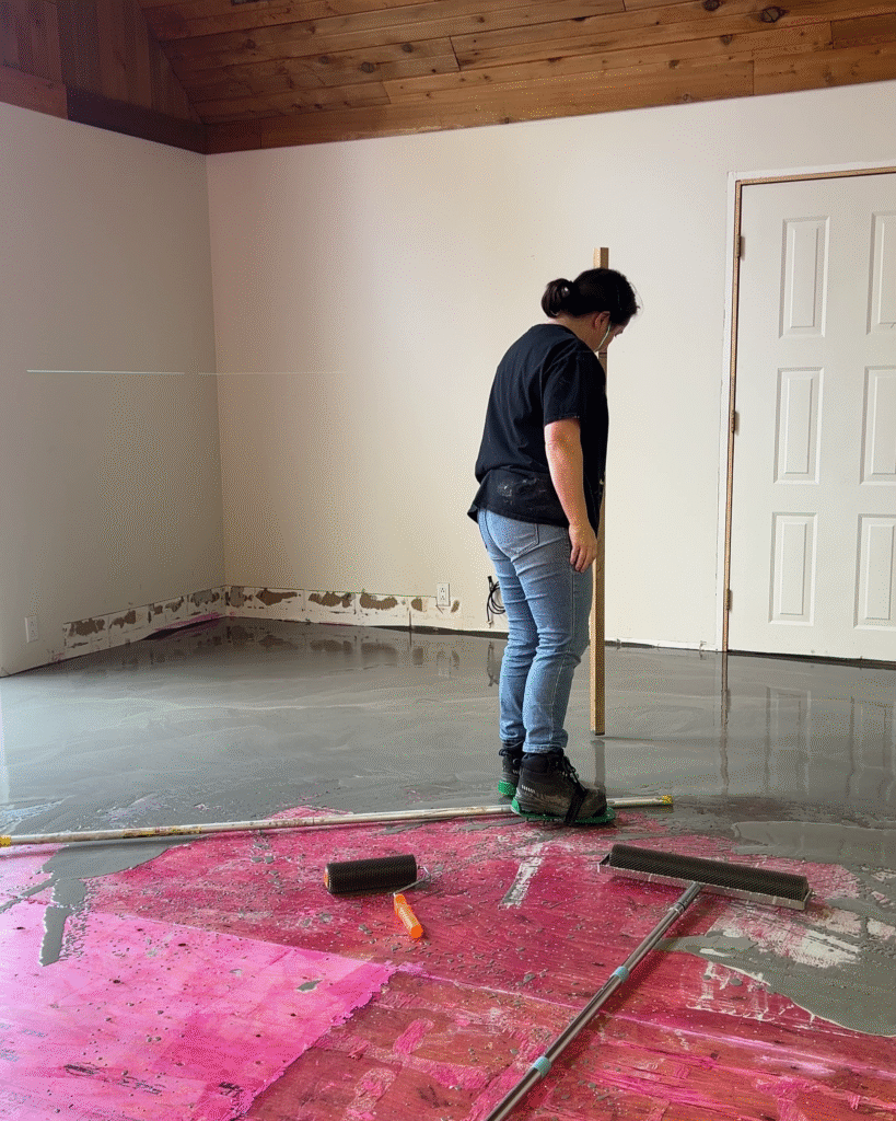 Using a measuring stick to see how level the floor is