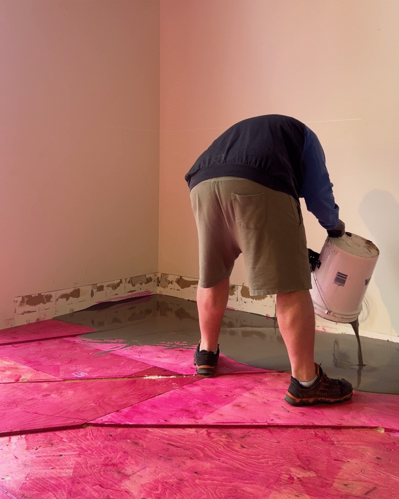 Pouring the concrete from a bucket onto the floor before spreading
