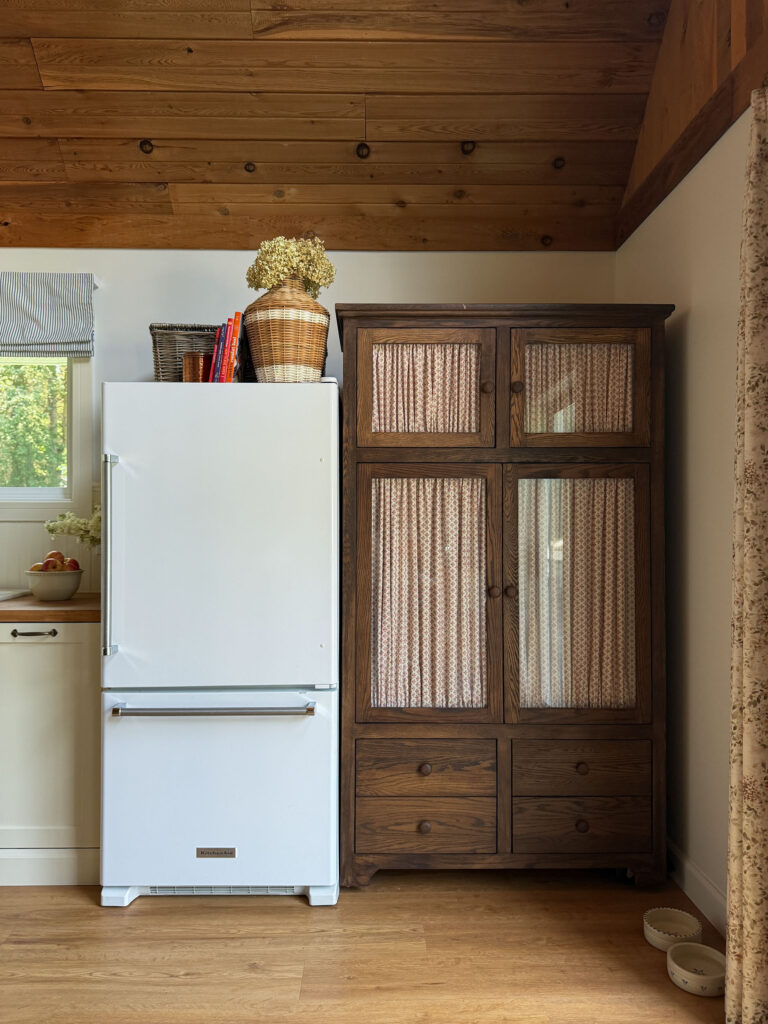 TV armoire turned into a pantry with glass doors and fabric