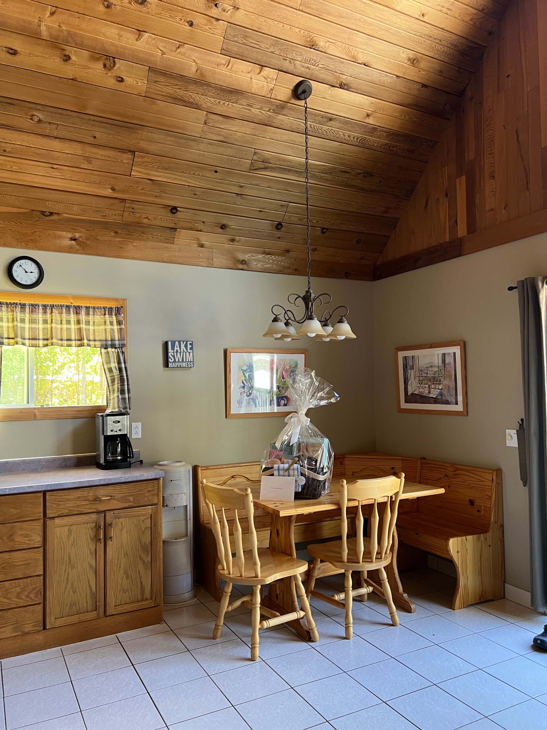 kitchen with wood cabinets, wood ceiling, corner table and chairs