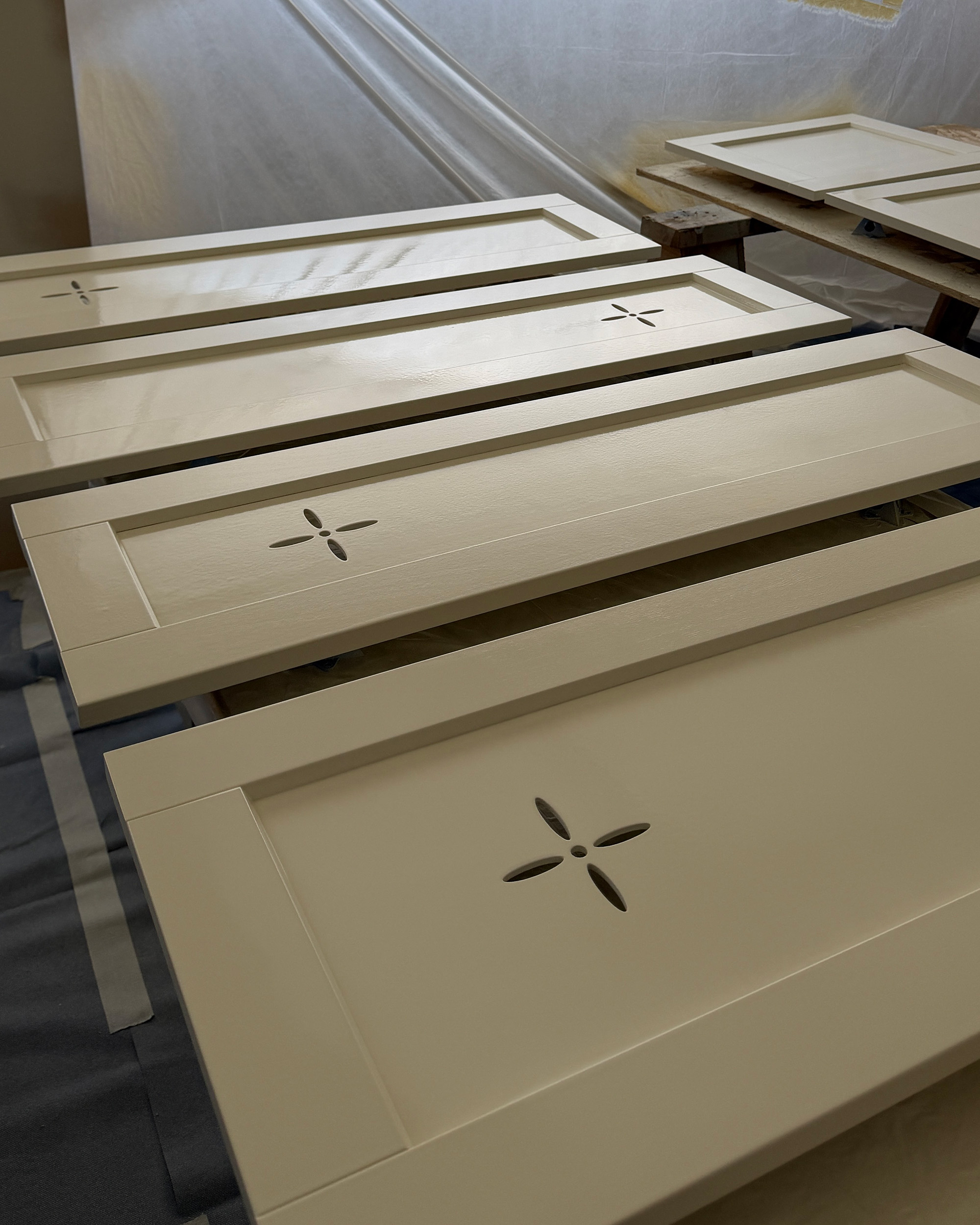 cabinet doors laying flat and freshly painted
