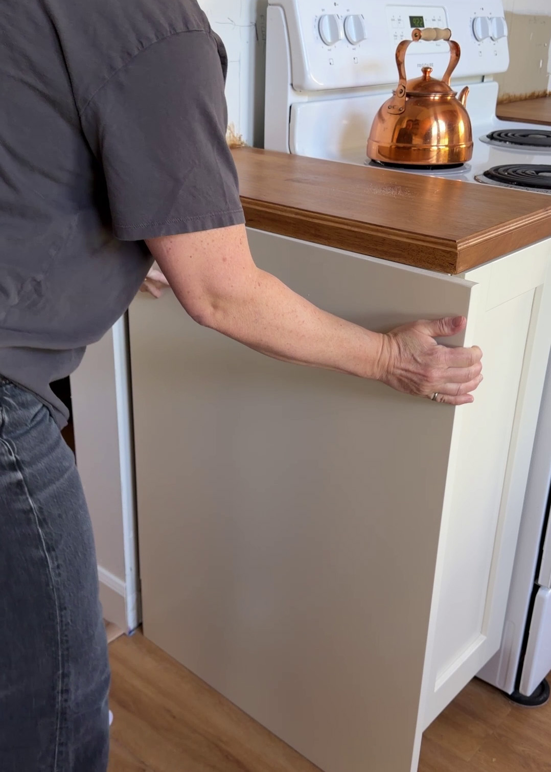 Installing a side panel on a kitchen end cabinet