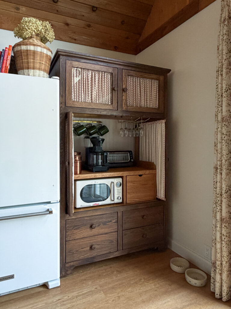 TV armoire turned into a pantry with glass doors and fabric 