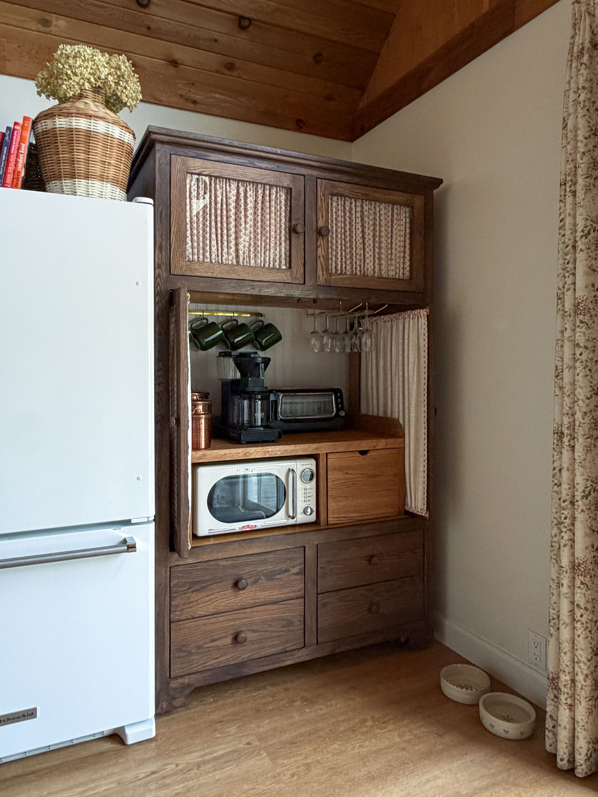 TV armoire turned into a pantry with glass doors and fabric