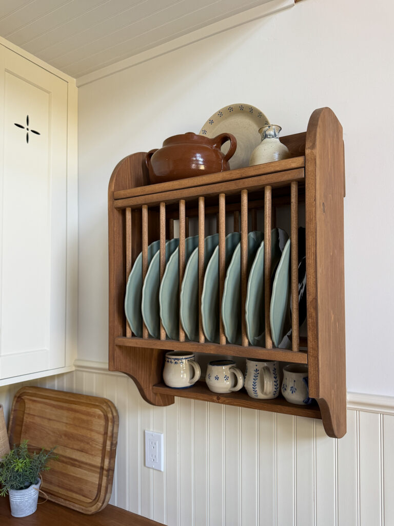 wooden plate rack with green dishes