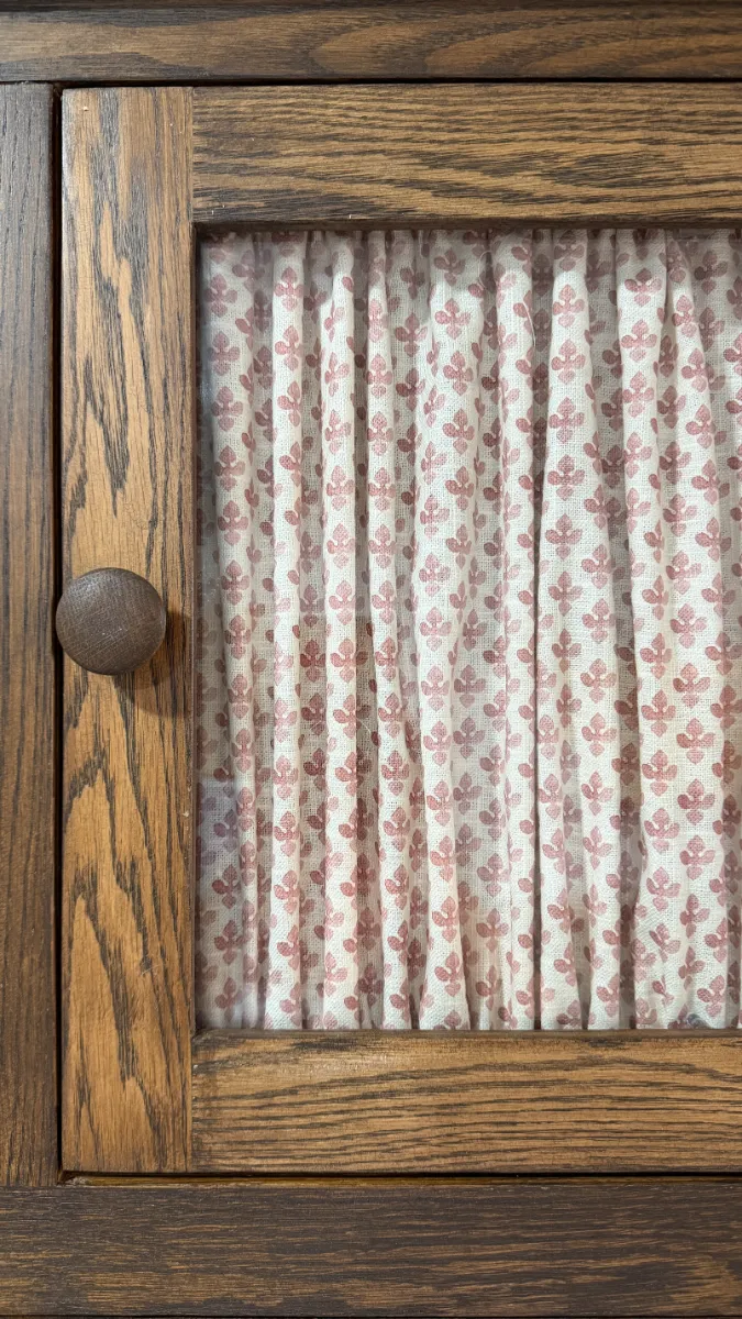 Close up of a glass door with a curtain on the inside
