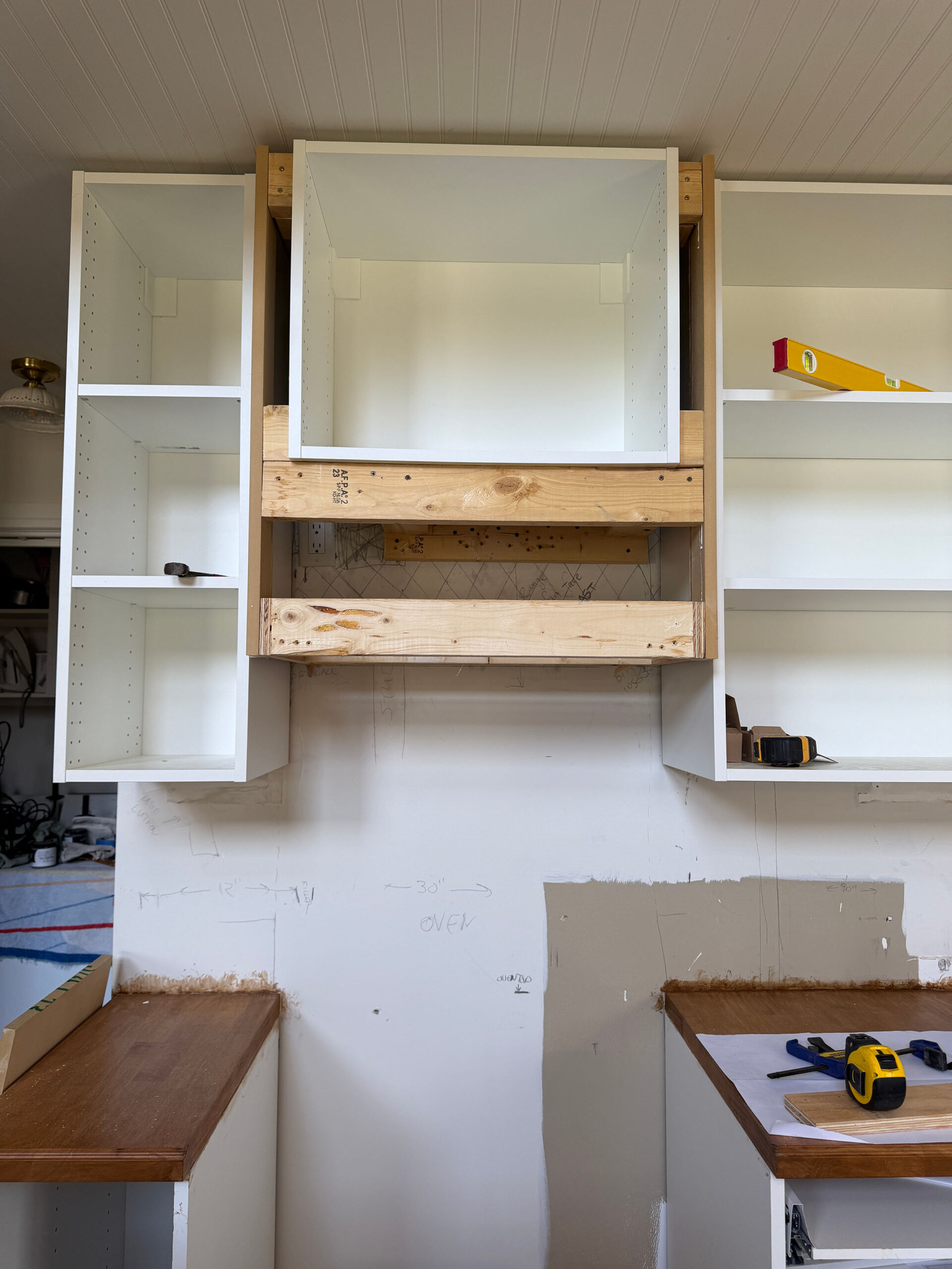 hood vent framed out with a cabinet above